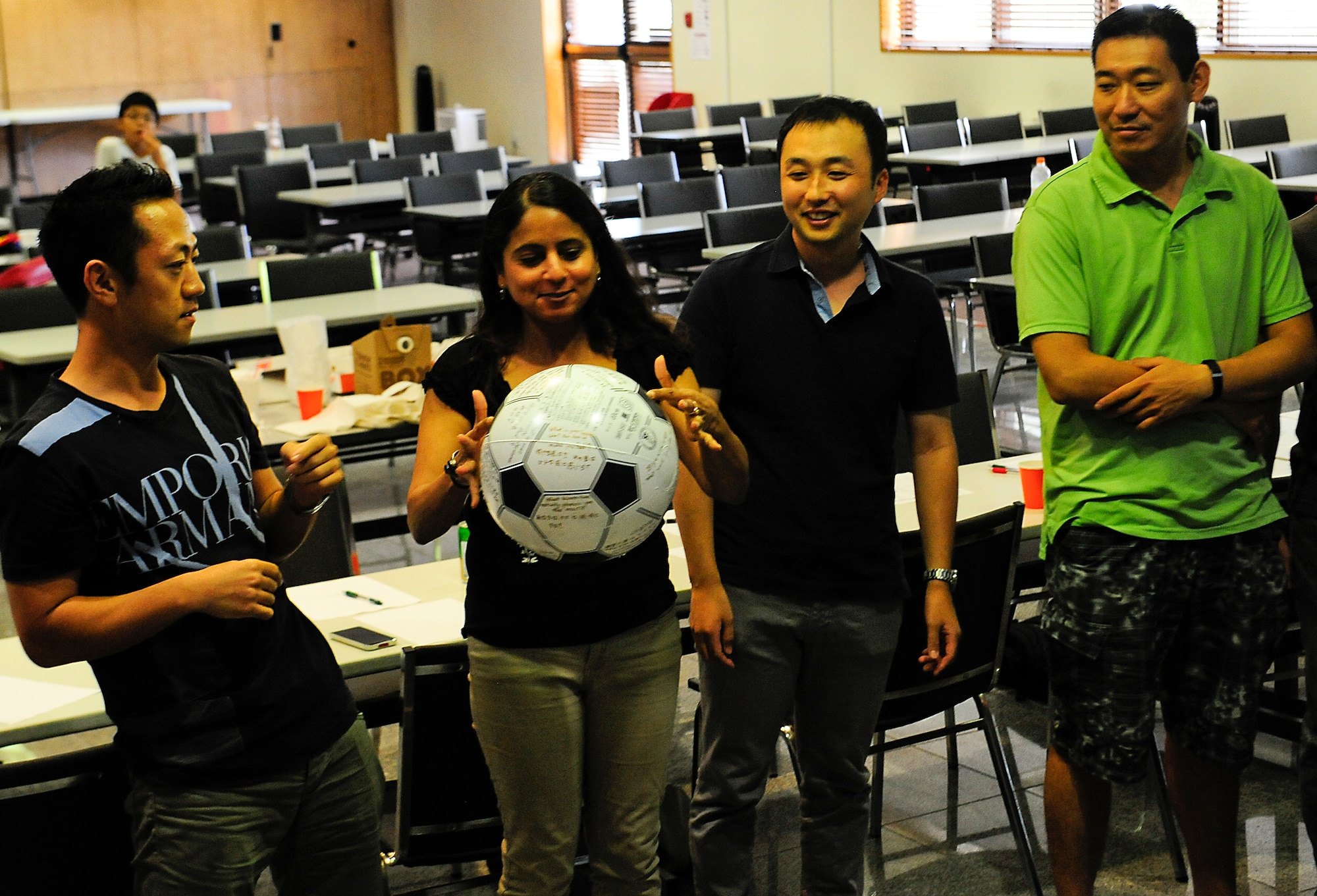 A group of U.S. Air Force and Japan Air Self-Defense Force officers throw around a ball with questions on it as a fun way to get to know each other during a Japanese English Mutual Study program at the Schilling Community Center, Kadena Air Base, Japan, Aug. 29, 2015. The goal of this game is to get to know each other better by throwing the ball and answering the question closest to where their thumb lies when they catch it. (U.S. Air Force Photo by Airman 1st Class Corey M. Pettis)