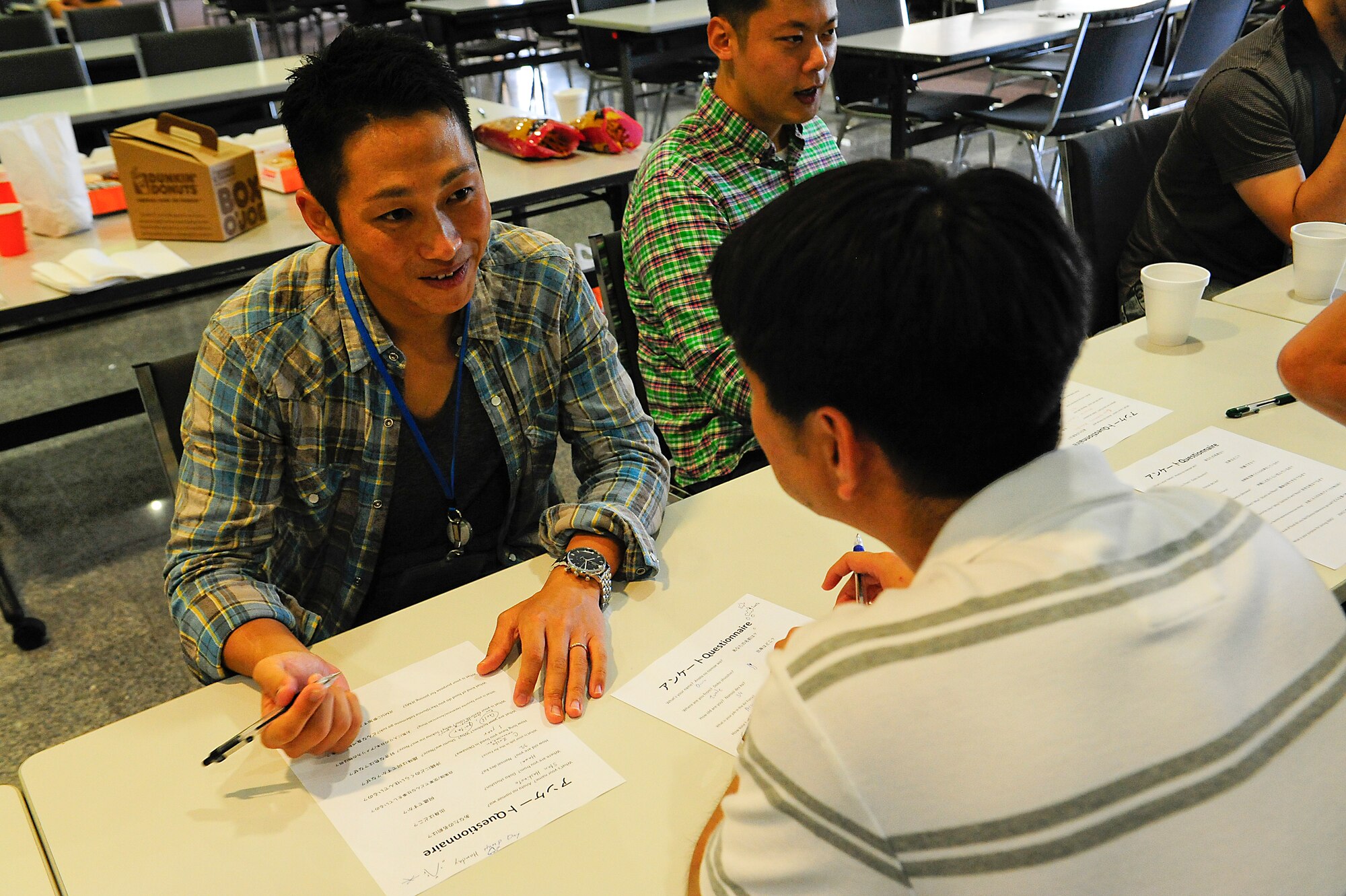 Kazuyoshi Omura, a personnel officer with the Japan Air Self-Defense Force, asks his American counterpart questions about himself during a Japanese English Mutual Study program at the Schilling Community Center, Kadena Air Base, Japan, Aug. 29, 2015. The goal of JEMS is to strengthen ties between both militaries and the two countries. (U.S. Air Force Photo by Airman 1st Class Corey M. Pettis)                                                    