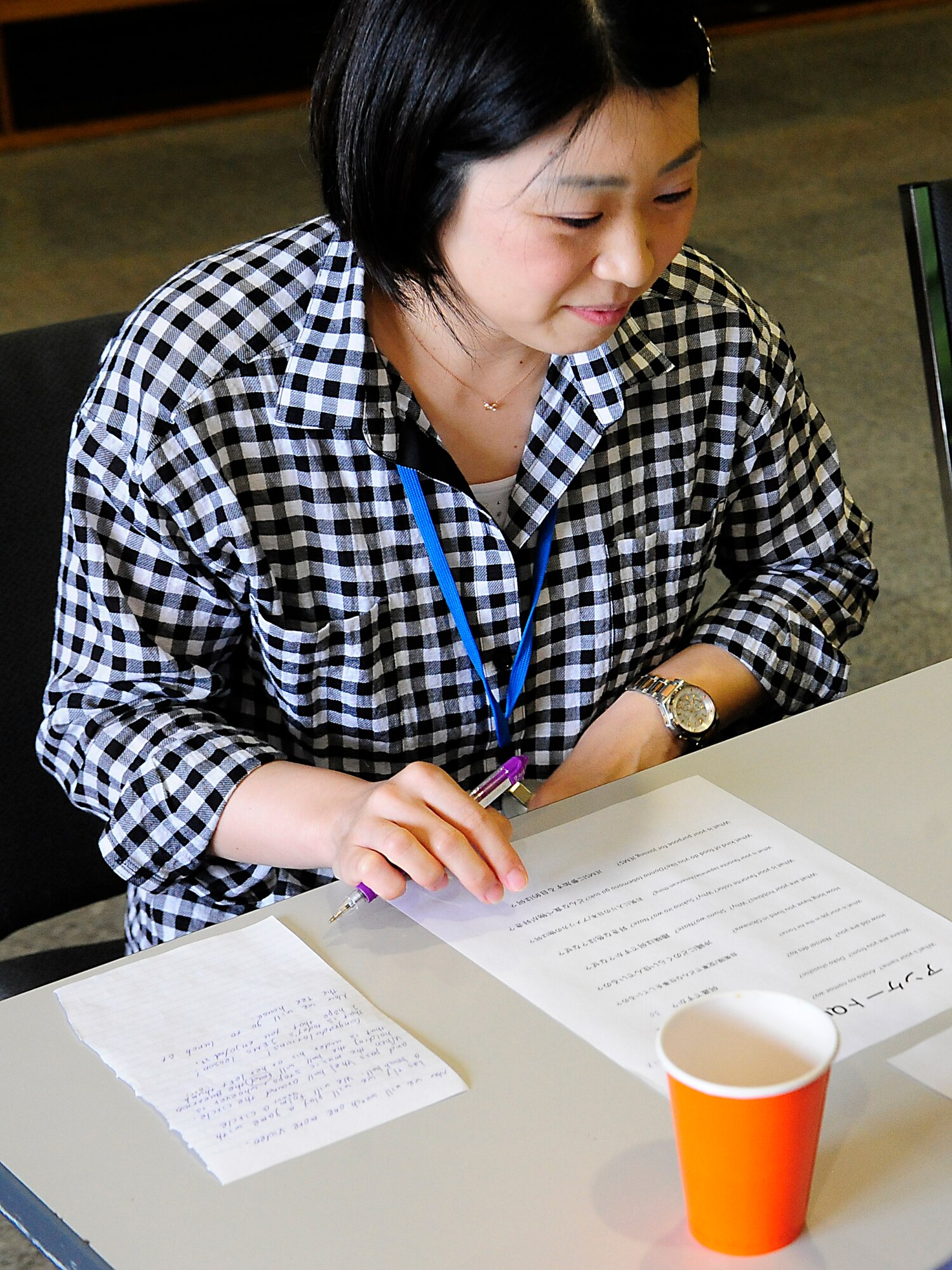 Yukio Suzuki, a Mental Health officer with Japan Air Self-Defense Force, writes down her American counterpart’s answers to a questionnaire during a Japanese English Mutual Study program at the Schilling Community Center, Kadena Air Base, Japan, Aug. 29, 2015. Participants were asked to fill out a questionnaire about the person they were talking to, and then present their new friend to the group. (U.S. Air Force Photo by Airman 1st Class Corey M. Pettis)