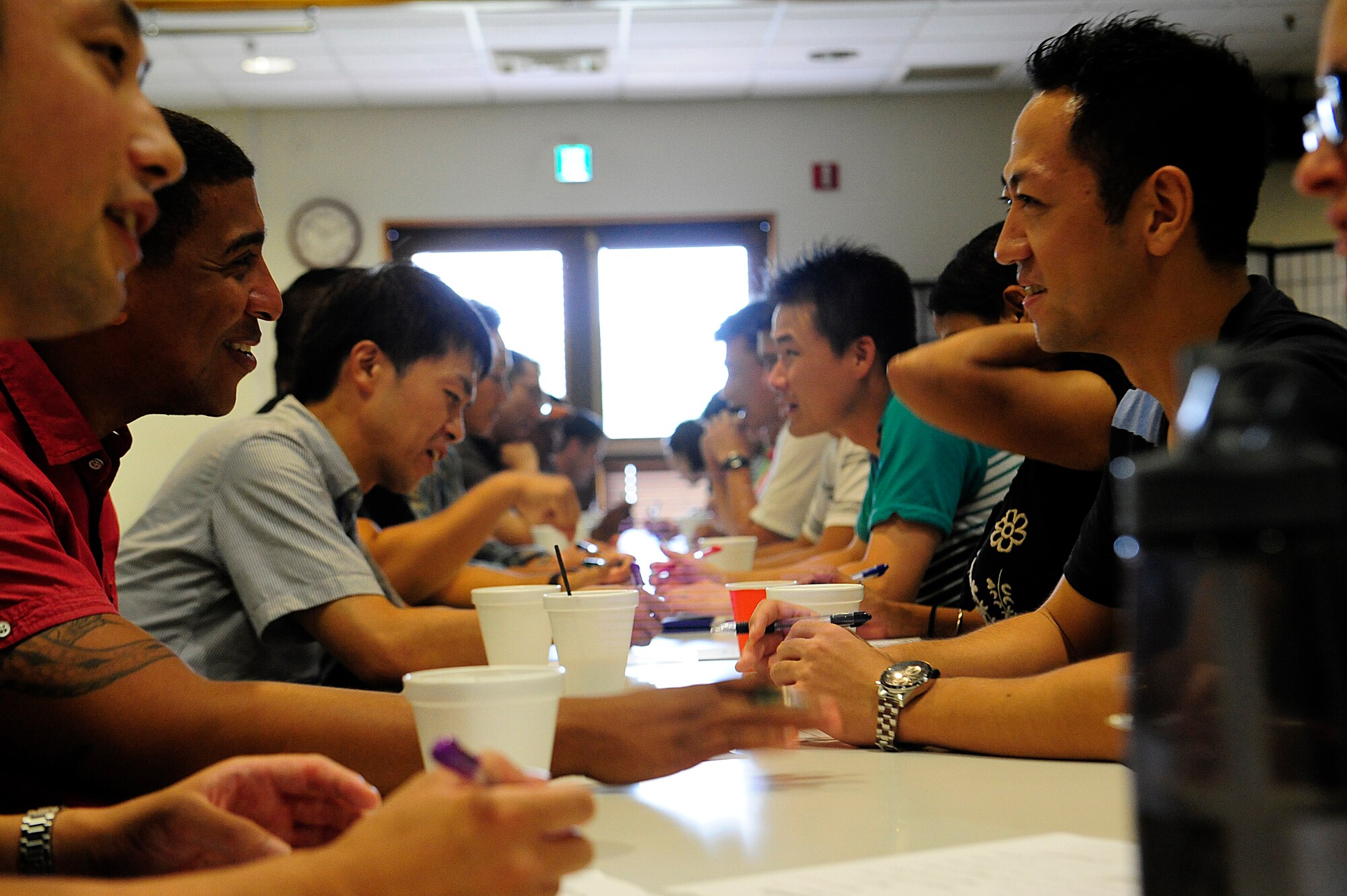 U.S. Air Force and Japan Air Self-Defense Force officers talk with each other during a Japanese English Mutual Study program at the Schilling Community Center, Kadena Air Base, Japan, Aug. 29, 2015. JEMS is a program where officers from JASDF and the U.S. Air Force get together to learn about each other’s language, culture, and to bridge stronger lines of communication between the two countries. (U.S. Air Force Photo by Airman 1st Class Corey M. Pettis)