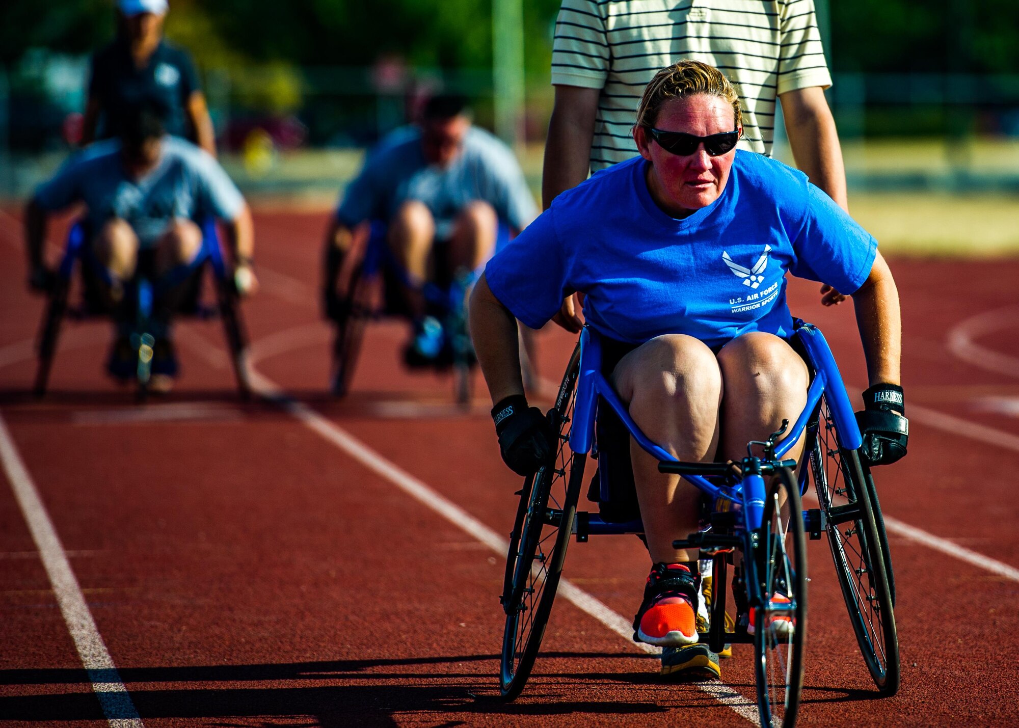 A Wounded Warrior races in a wheel chair while participating in track and field training during the Air Force Wounded Warrior Program Warrior Care event, Aug. 26, 2015 at Joint Base Lewis-McChord, Wash. The Warrior Care event featured adaptive and rehabilitative sports, activities, career readiness, recovering Airman mentorship and caregiver training. It was an opportunity for all wounded, ill and injured service members to engage in friendly competition. Wounded Warriors from JBLM and veterans from the northwest region were all invited to participate in the camp. (U.S. Air Force Reserve photo by Senior Airman Daniel Liddicoet