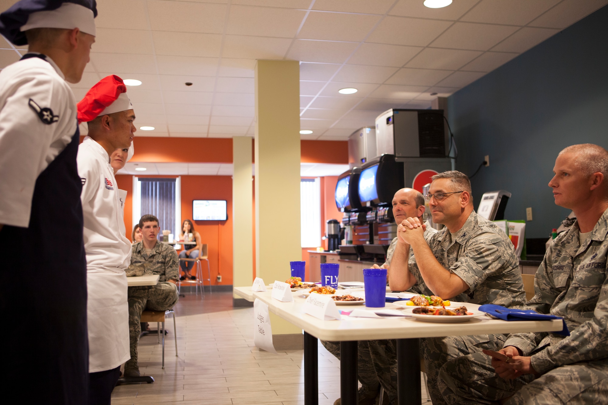 Col. Trevor Flint, 90th Maintenance Group commander; Col. Stephen Kravitsky, 90th Missile Wing commander; and Chief Master Sgt. John Facemire, 90th Mission Support Group command chief, judge the entrees and desserts presented to them during a culinary competition held at the Chadwell Dining Facility on F.E. Warren Air Force Base, Wyo., Aug. 27, 2015. The winning entree was a peanut butter cracker crusted chicken roulade with herb cream sauce and a brownie, chocolate panna cotta, caramel tuile cookie and chocolate drizzle for dessert. (U.S. Air Force photo by Lan Kim)