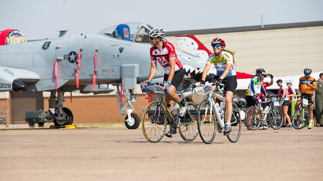 Cyclists pass through ‘Air Power Alley’ on Sheppard Air Force Base, Texas, during the Hotter’N Hell 100 bike ride, Aug. 29, 2015. During their visit to Sheppard, the cyclists were able to stop to take photos of the different Aircraft and visit with a few of the Airmen. Events such as the Hotter’N Hell 100, promote fitness in and around the community. (U.S. Air Force photo by Senior Airman Kyle Gese/Released)