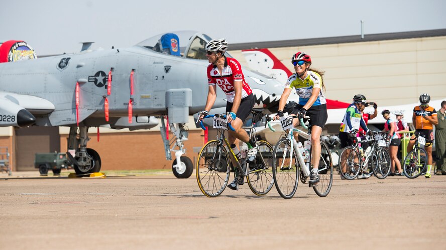 Cyclists pass through ‘Air Power Alley’ on Sheppard Air Force Base, Texas, during the Hotter’N Hell 100 bike ride, Aug. 29, 2015. During their visit to Sheppard, the cyclists were able to stop to take photos of the different Aircraft and visit with a few of the Airmen. Events such as the Hotter’N Hell 100, promote fitness in and around the community. (U.S. Air Force photo by Senior Airman Kyle Gese/Released)