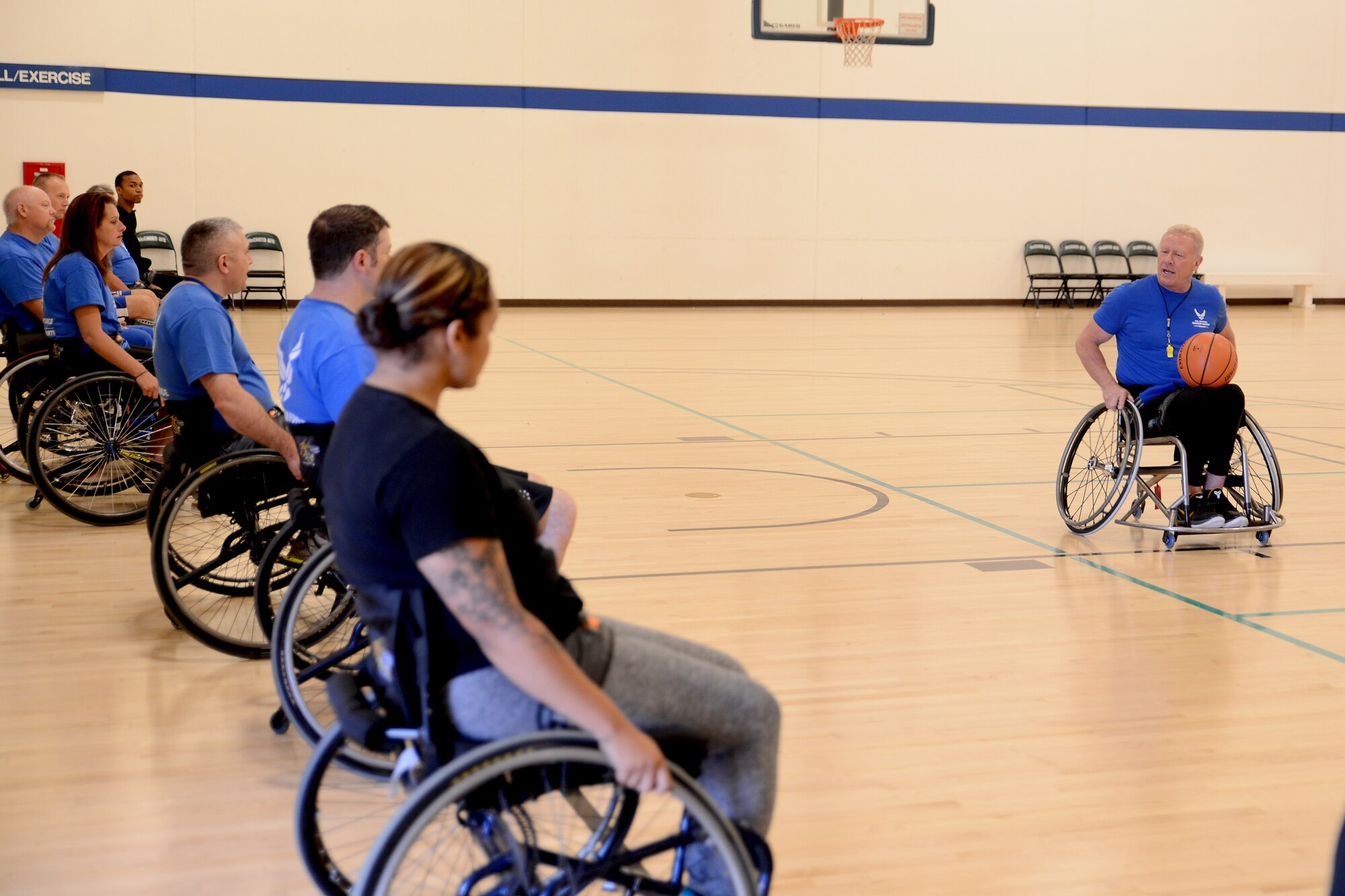 Mark Shepherd (right), Adaptive Sports Camp wheelchair basketball coach, instructs athletes on wheelchair movements Aug. 25, 2015, during the Wounded Warriors Adaptive Sports Camp at Joint Base Lewis-McChord, Wash. Athletes that participated in the camp practiced various sports throughout the week before a final competition, Aug. 28, 2015. (U.S. Air Force photo/Airman 1st Class Keoni Chavarria)