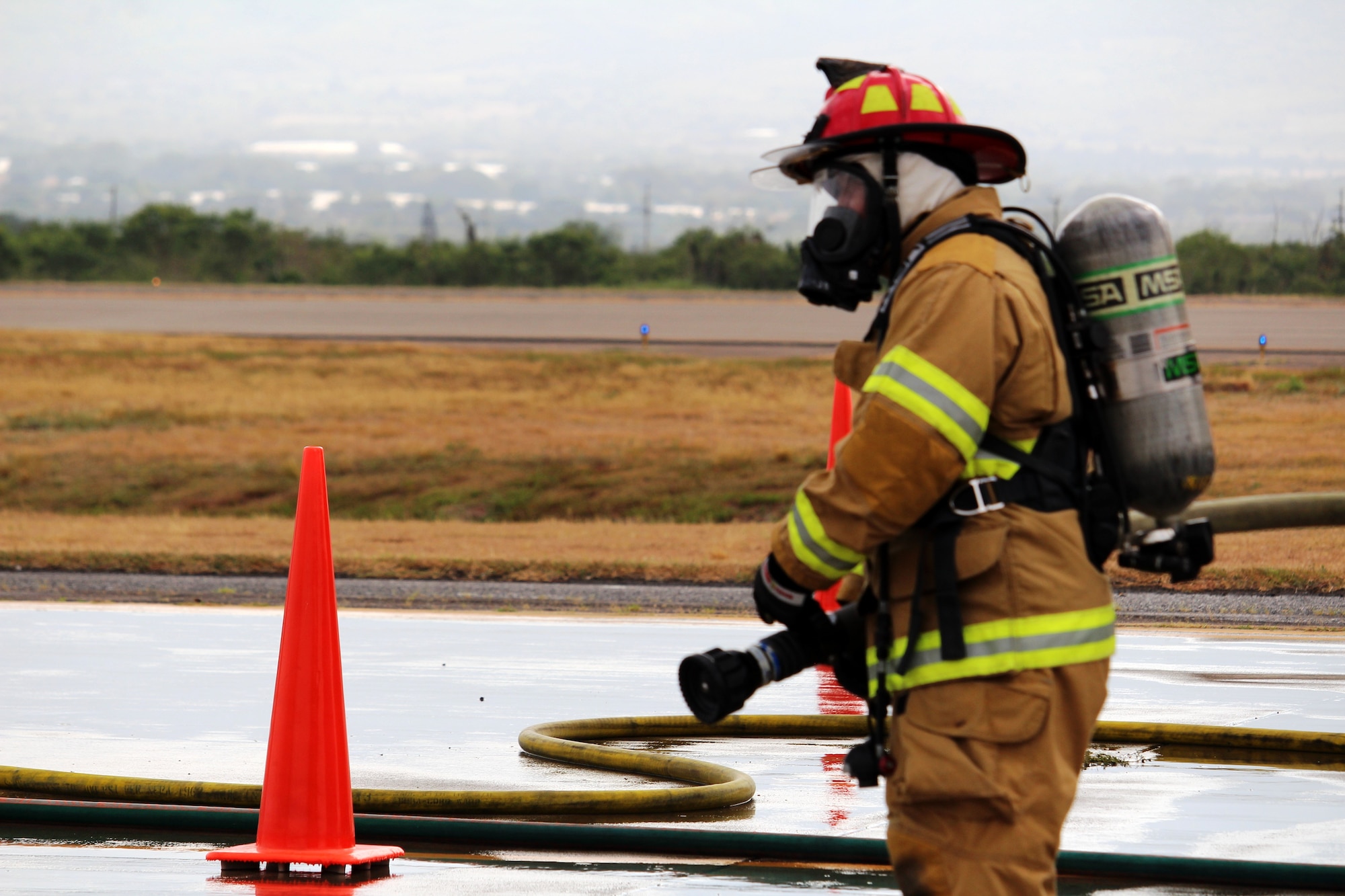 SOTO CANO AIR BASE, Honduras - Miguel Matus, a firefighter form the Belize nNational Fire Service, prepares for a mobile aircraft fire practice Aug. 26, 2015, during CENTAM SMOKE, a quarterly firefighting exercise hosted by Joint Task Force-Bravo at Soto Cano Air Base, Honduras. During this practice, students learned how to combat live fires in the cockpit, engine, fuselage and ground areas of the aircraft to build partnership and improve interoperability.  (U.S. Army photo by Maria Pinel)