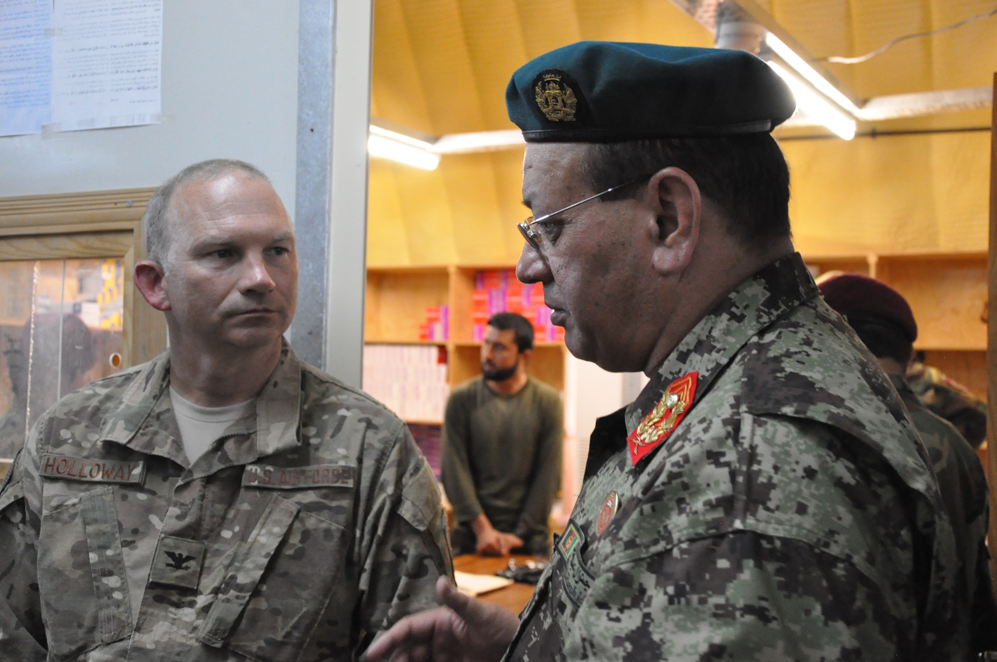 Helmand, Afghanistan (July 25, 2015) - Maj. Gen. Eqbil Ali Afghan Ministry of Defense General Staff, G6, Communications and U.S. Air Force Col. Donald Holloway, Resolute Support Advise and Assist Cell-Southwest team lead, discuss advancements in 215th Corps' field medical care.  
