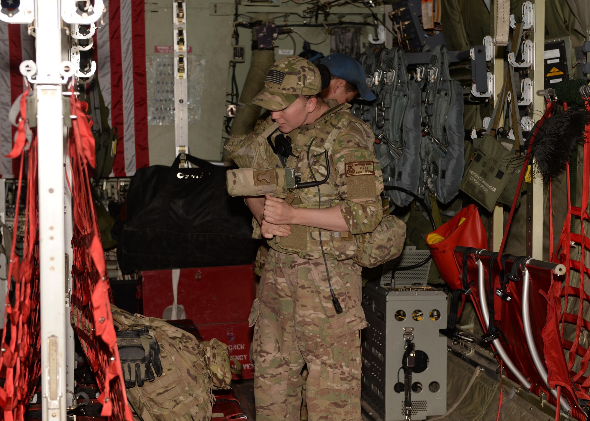 U.S. Air Force Staff Sgt. Brandee Hahn, 455th Expeditionary Security Forces Squadron noncommissioned officer in charge of the fly away security team, gears up before stepping off of a C-130J Super Hercules aircraft to provide security Aug. 28, 2015, at Hamid Karzai International Airport, Kabul, Afghanistan. Hahn is a FAST member and is responsible for protecting mission essential assets, the aircraft and crew members when flying to locations that have limited airfield security. (U.S. Air Force photo by Senior Airman Cierra Presentado/Released)