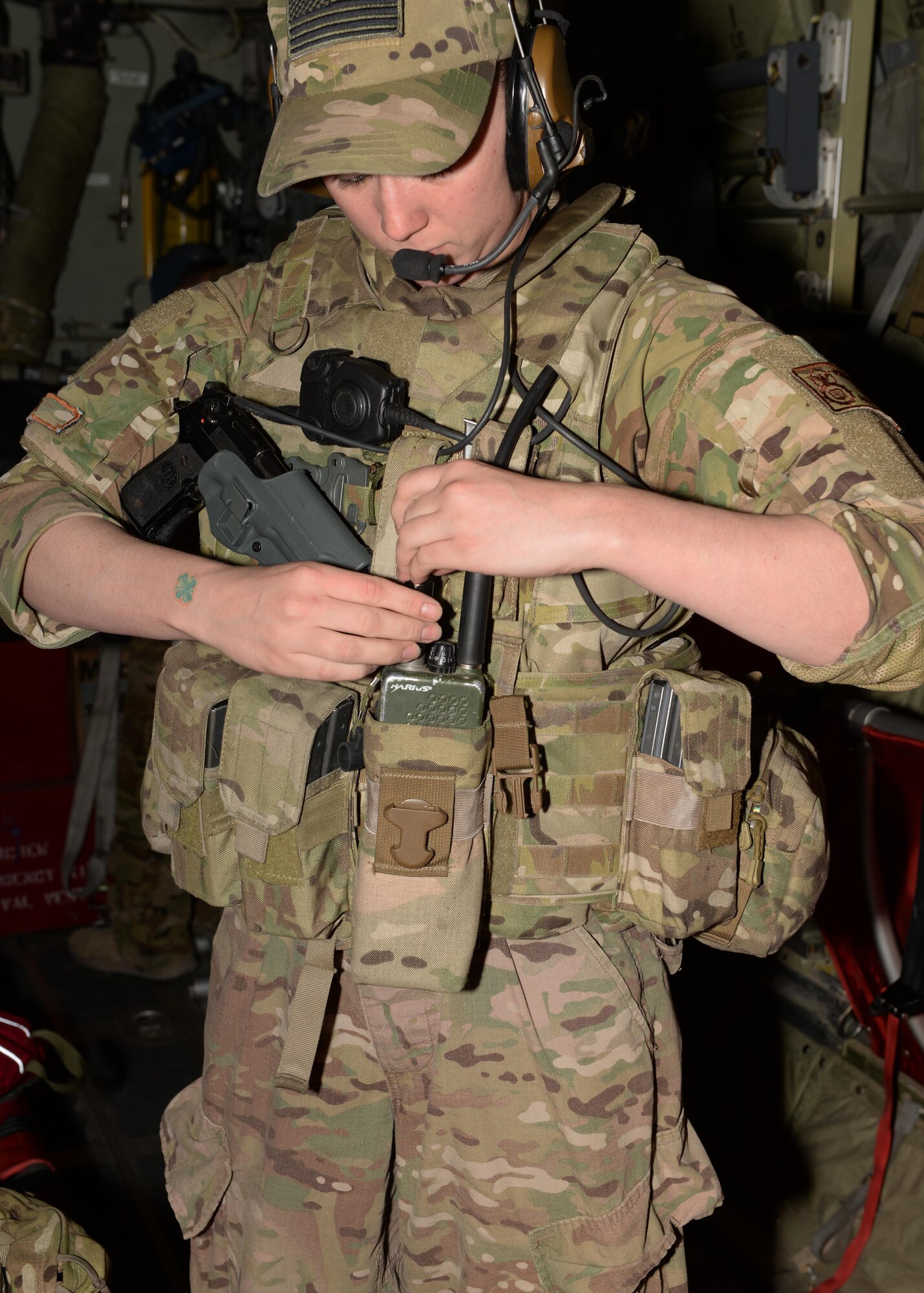 U.S. Air Force Staff Sgt. Brandee Hahn, 455th Expeditionary Security Forces Squadron noncommissioned officer in charge of the fly away security team, gears up before stepping off of a C-130J Super Hercules aircraft to provide security Aug. 28, 2015, at Hamid Karzai International Airport, Kabul, Afghanistan. Hahn is a FAST member and is responsible for protecting mission essential assets, the aircraft and crew members when flying to locations that have limited airfield security. (U.S. Air Force photo by Senior Airman Cierra Presentado/Released)
