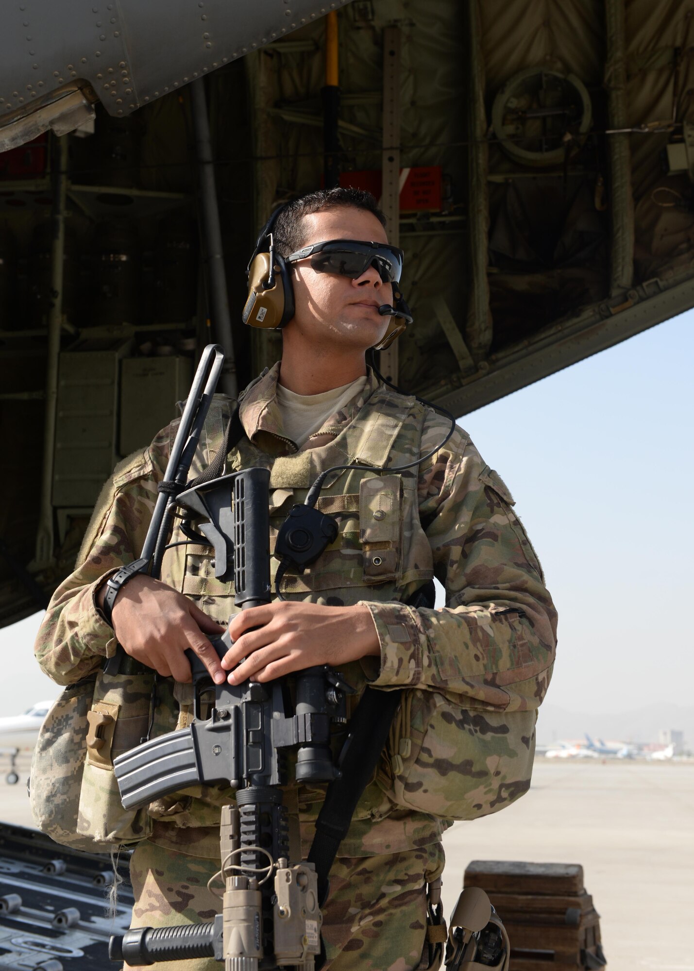 U.S. Air Force Airman 1st Class Wilmer Puello, 455th Expeditionary Security Forces Squadron fly away security team member, stands watch outside of a C-130J Super Hercules aircraft Aug. 28, 2015, at Hamid Karzai International Airport, Kabul, Afghanistan. Puello is a FAST member and is responsible for protecting mission essential assets, the aircraft and crew members when flying to locations that have limited airfield security. (U.S. Air Force photo by Senior Airman Cierra Presentado/Released)