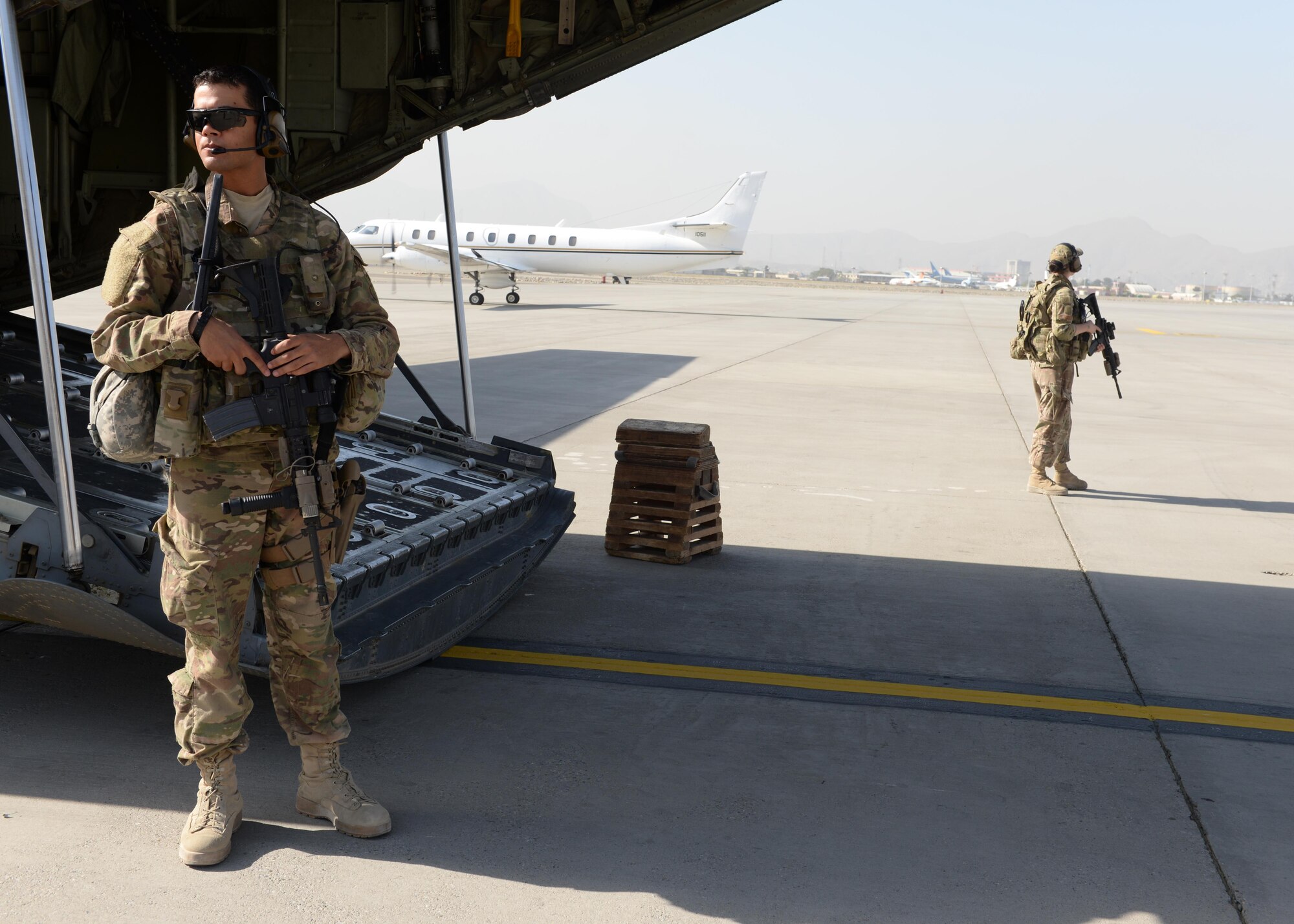 U.S. Air Force Airman 1st Class Wilmer Puello, left, and Staff Sgt. Brandee Hahn,  both 455th Expeditionary Security Forces Squadron fly away security team members provide security for a C130J-Super Hercules aircraft and crewmembers while on a mission Aug. 28, 2015, at Hamid Karzai International Airport, Kabul, Afghanistan. The team is responsible for protecting mission essential assets, the aircraft and crew members when flying to locations that have limited airfield security. (U.S. Air Force photo by Senior Airman Cierra Presentado/Released)