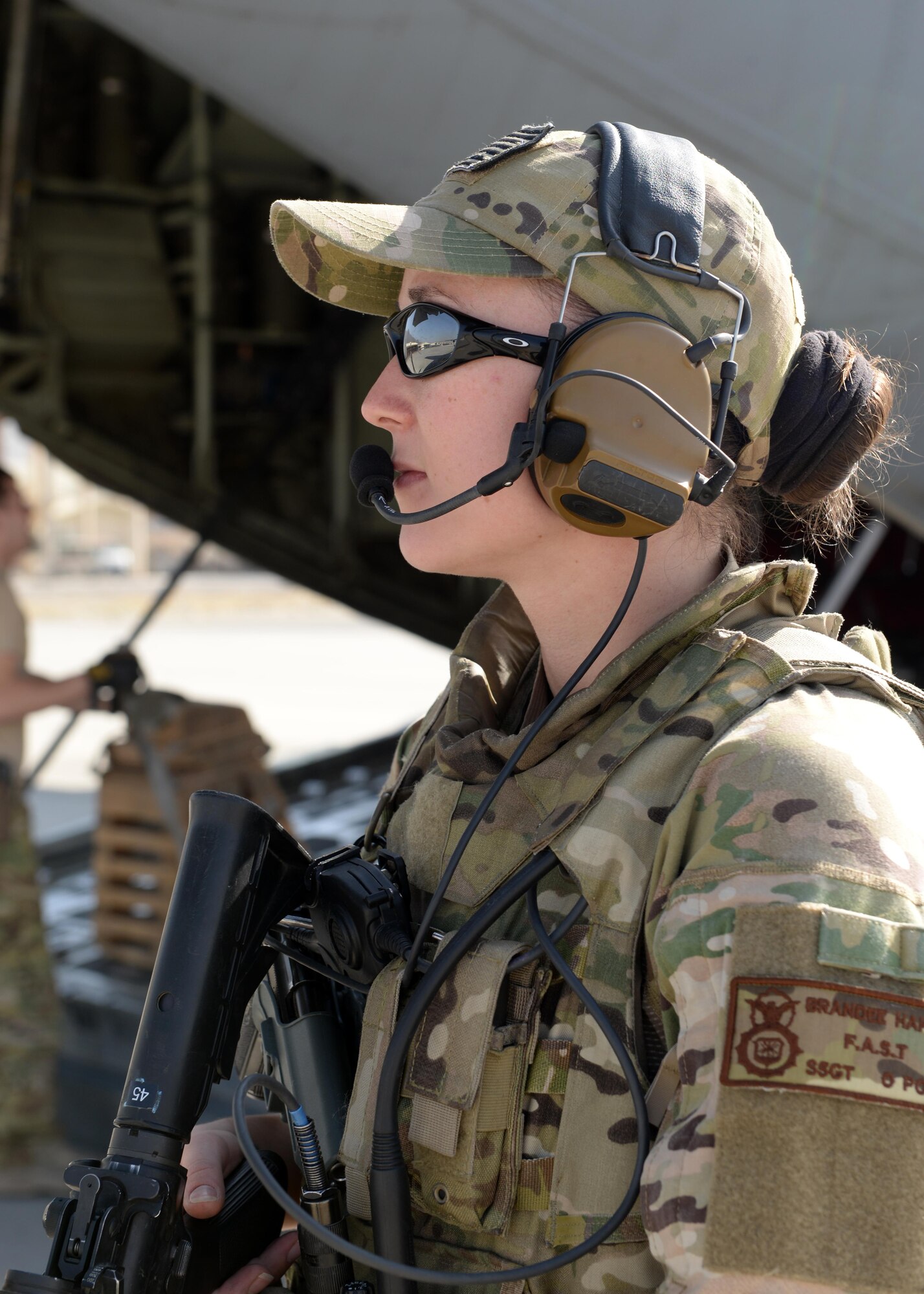U.S. Air Force Staff Sgt. Brandee Hahn, 455th Expeditionary Security Forces Squadron noncommissioned officer in charge of the fly away security team, provides security for a C-130J Super Hercules aircraft and crew members during a mission Aug. 28, 2015, Hamid Karzai International Airport, Kabul, Afghanistan. Hahn is a FAST member and is responsible for protecting mission essential assets, the aircraft and crew members when flying to locations that have limited airfield security. (U.S. Air Force photo by Senior Airman Cierra Presentado/Released)