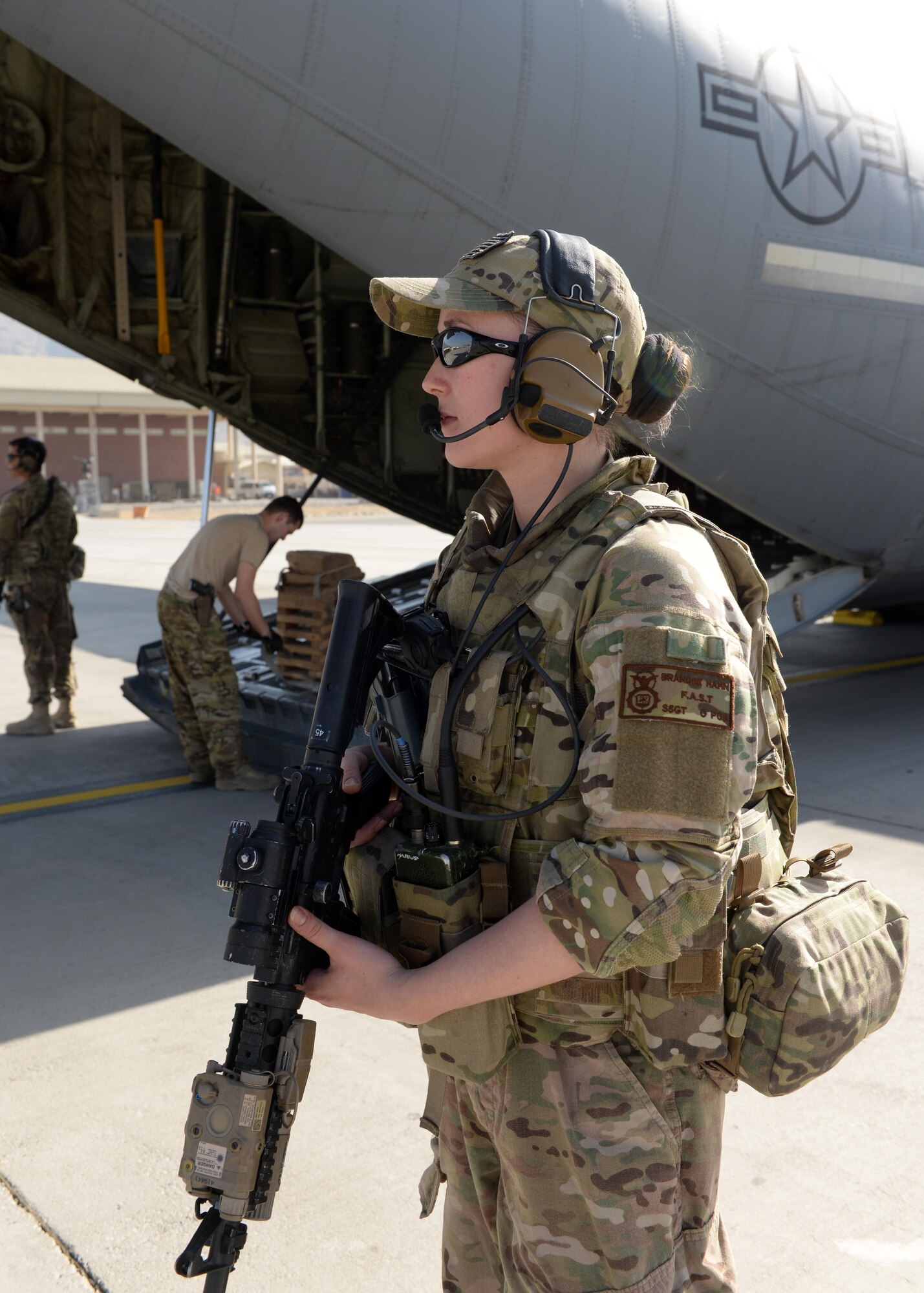U.S. Air Force Staff Sgt. Brandee Hahn, 455th Expeditionary Security Forces Squadron noncommissioned officer in charge of the fly away security team, provides security for a C-130J Super Hercules aircraft and crew members during a mission Aug. 28, 2015, Hamid Karzai International Airport, Kabul, Afghanistan. Hahn is a FAST member and is responsible for protecting mission essential assets, the aircraft and crew members when flying to locations that have limited airfield security. (U.S. Air Force photo by Senior Airman Cierra Presentado/Released)
