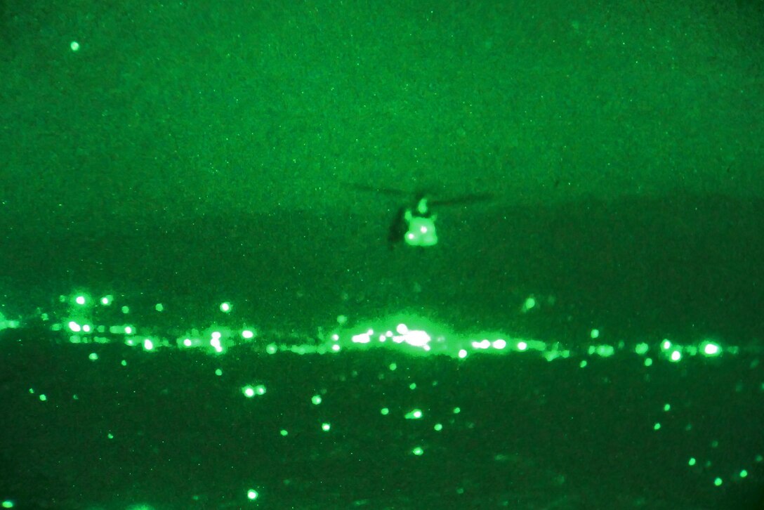 As seen through a night-vision device, a CH-47 Chinook helicopter transports U.S. soldiers and Marines, and Georgian, Czech and Afghan troops to conduct a night patrol outside Bagram Airfield in Parwan province, Afghanistan, Aug. 17, 2015. U.S. Army photo by Sgt. 1st Class David Wheeler