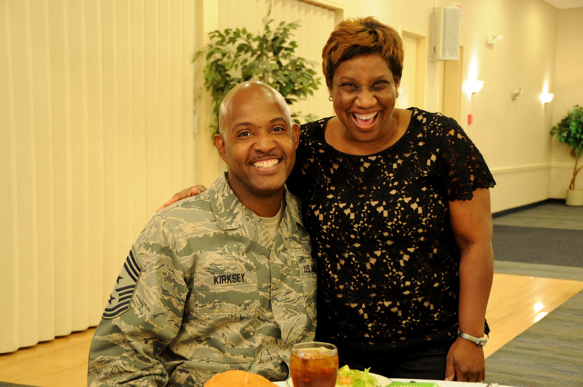 Air Force Reserve Command Chief Master Sgt. Cameron B. Kirksey shares a moment with Karla Redding-Andrews, the daughter of the late Otis Redding, during the Leadership Macon luncheon at Robins Air Force Base, Ga. Community and business leaders from Bibb County visited to learn about the mission capabilities and gain an awareness of the base's role in national security. (U.S. Air Force photo/Tech Sgt. Mercedes Crossland)