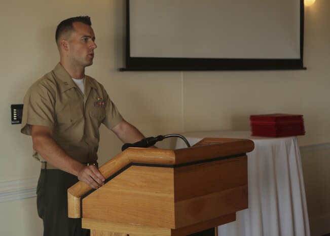 Capt. Brian D. Hall, the Marine Aircraft Group 26 Intelligence officer in charge, congratulates intelligence specialist Marines during their Squadron Intelligence Training and Certification Course graduation ceremony on Marine Corps Air Station New River, Aug. 28, 2015. The students spent 19 training days and more than 90 class hours learning aviation-specific intelligence skills such as structured analytic techniques, comprehensive threat education, capabilities and limitation of all Marine Corps aircraft and how to support a large scale exercise. (U.S. Marine Corps photo by Cpl. Michelle Reif/Released.)