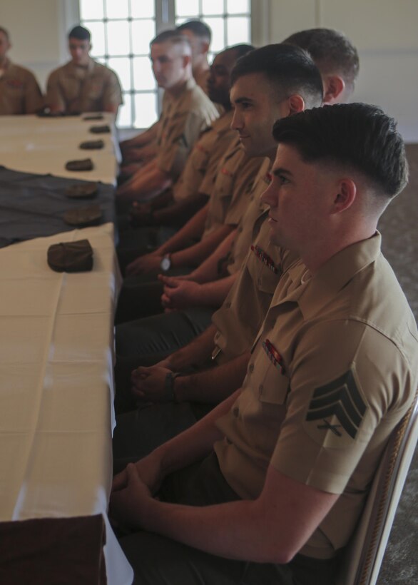 Ten intelligence specialist Marines listen to congratulatory speeches during their Squadron Intelligence Training and Certification Course graduation ceremony on Marine Corps Air Station New River Aug. 28, 2015. The students spent 19 training days and more than 90 class hours learning aviation-specific intelligence skills such as structured analytic techniques, comprehensive threat education, capabilities and limitation of all Marine Corps aircraft and how to support a large scale exercise. (U.S. Marine Corps photo by Cpl. Michelle Reif/Released.)