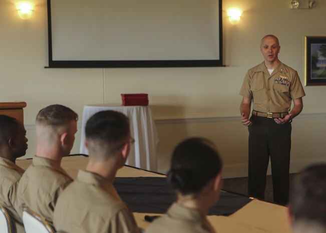 Lt. Col. Brett A. Hart, the executive officer of Marine Aircraft Group 26, speaks to intelligence specialist Marines during their Squadron Intelligence Training and Certification Course graduation ceremony on Marine Corps Air Station New River, Aug. 28, 2015. The students spent 19 training days and more than 90 class hours learning aviation-specific intelligence skills such as structured analytic techniques, comprehensive threat education, capabilities and limitation of all Marine Corps aircraft and how to support a large scale exercise. (U.S. Marine Corps photo by Cpl. Michelle Reif/Released.)