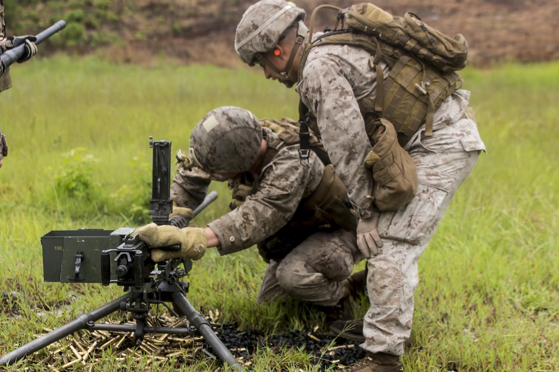 A Marine with 2nd Air Naval Gunfire Liaison Company performs a barrel change on the M2 .50 Caliber Heavy Machine Gun during a week-long field exercise at Camp Lejeune, N.C., Aug. 27, 2015. The Marines were conducting this training in order to uphold their readiness and standards in support of II Marine Expeditionary Force and to re-familiarize themselves with the weapons system. (U.S. Marine Corps photo by Cpl. Krista James/Released)