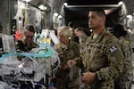 North Carolina Air National Guard Tech. Sgt. Russell McLamb, an aeromedical evacuation technician, helps load an injured service member onto a C-17 Globemaster III on the flight line at Bagram Airfield, Afghanistan, Aug. 8, 2015. McLamb, a veteran of three branches of the military, is deployed from the 156th Aeromedical Evacuation Squadron, based in Charlotte, North Carolina, to the 455th Expeditionary Aeromedical Evacuation Squadron at Bagram. 