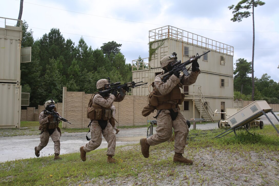 Crossing the danger zone between two buidlings, Marines from Fox Company, 2nd Battalion, 2nd Marine Regiment, secure entry to the building they are to clear as part of their military operations in urban terrain training aboard Camp Lejeune, N.C., Aug. 26, 2015. They began with team movements and worked their way up to sqaud-level sized movements. (U.S Marine Corps photo by Pfc. Miranda Faughn/released)
 
