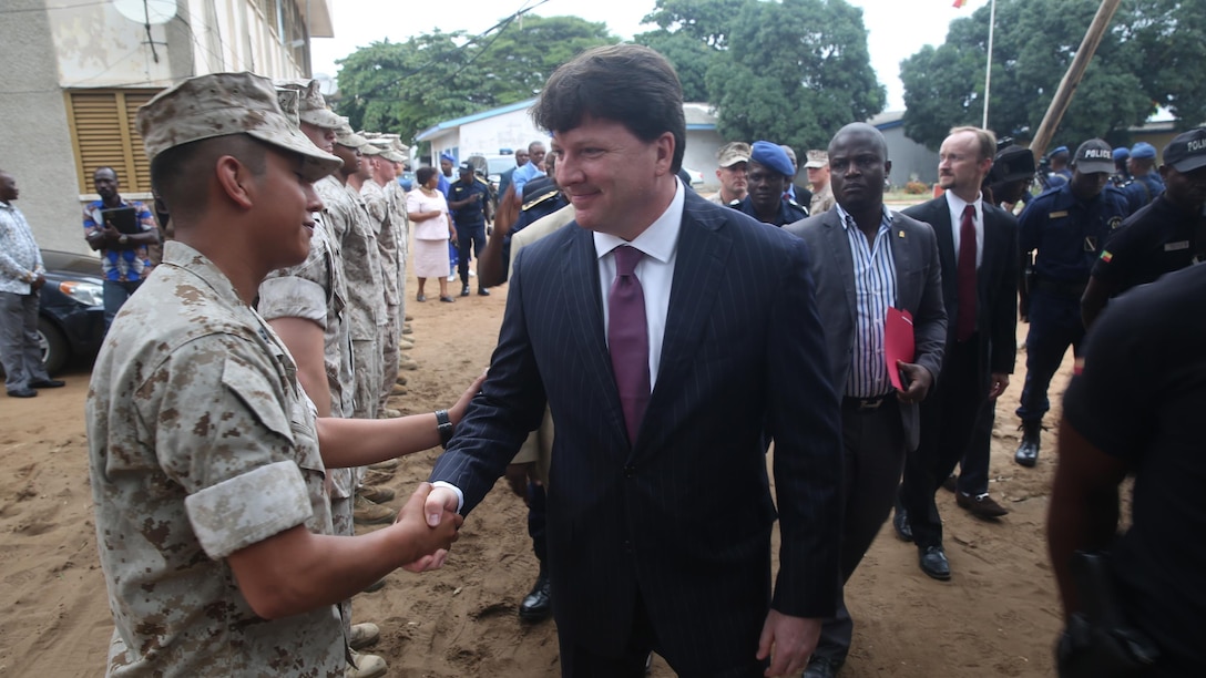 U.S. Embassy Benin Chargé d'affaires Todd Whatley greets U.S Marines and sailors, with Special-Purpose Marine Air-Ground Task Force Crisis Response-Africa Detachment A, during an opening ceremony, Aug. 31, 2015, that officially started training with between the U.S. Marines and sailors and Benin's National Surveillance Police at Benin's National Police Academy in Cotonou, Benin. Today’s ceremony marks a new milestone of the partnership between Benin and the U.S. This training is the first time in the Nation Surveillance Police’s 10-year history a foreign military has come to train and mentor the specialized unit. Benin's Minister of Interior Placide Azande was also on hand for the ceremony. 
