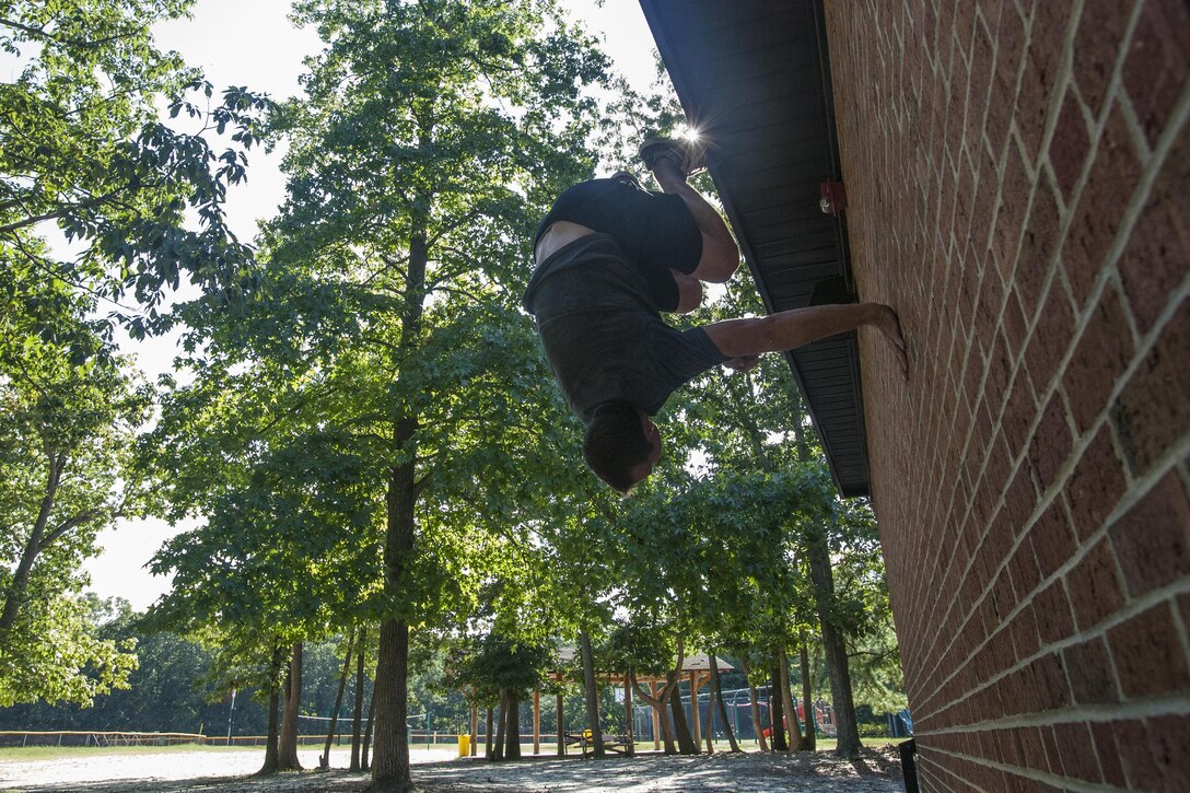 New Jersey Air National Guard Tech. Sgt. Justin B. Gielski performs a flip on a wall while training to compete on the TV show “American Ninja Warrior” at a playground near his home in Medford, N.J., Aug. 21, 2015. Gielski placed fifth in the all-military preliminary round and advanced to the finals in Las Vegas to compete alongside 100 others who made it through city qualifying rounds, but he was not among 16 who finished the obstacle course and earned a spot in the second stage of the four-stage finals. Gielski is a loadmaster with the 150th Special Operations Squadron, 108th Wing at Joint Base McGuire-Dix-Lakehurst, N.J. New Jersey Air National Guard photo by Master Sgt. Mark C. Olsen
