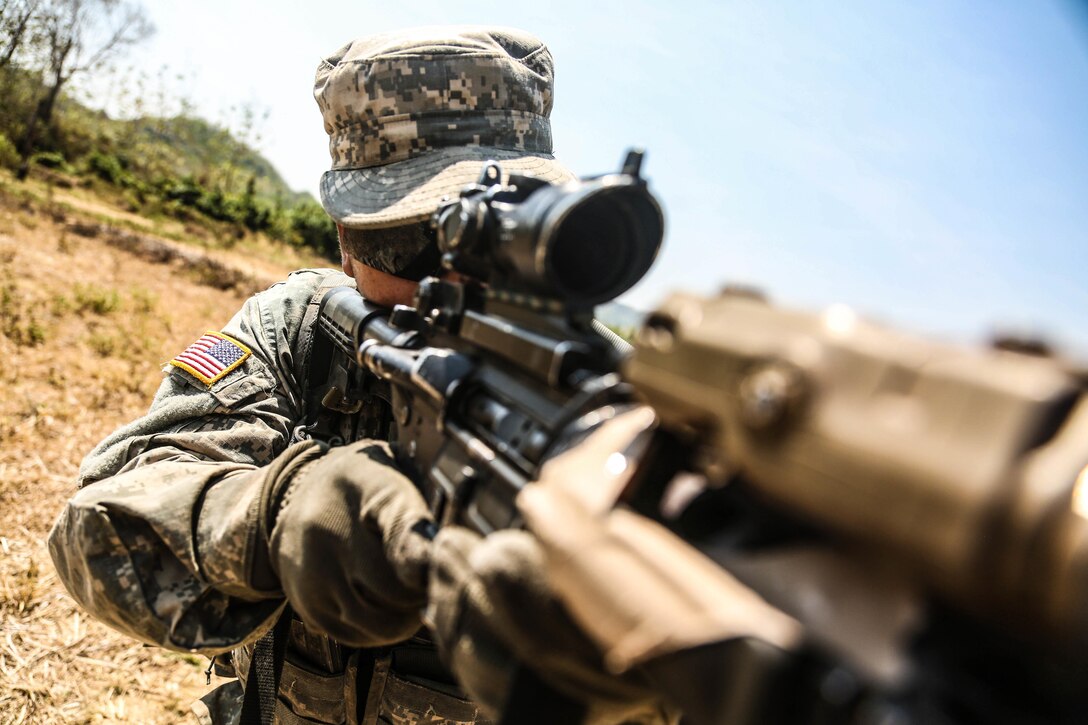 U.S. Army Pvt. Tomas Ordonez prepares to fire his M4 carbine rifle during Garuda Shield 2015 in Cibenda in West Java, Indonesia, Aug. 24, 2015. U.S. Army Pacific sponsored the bilateral exercise and the Indonesian army hosted it to promote regional security and cooperation. Ordonez is assigned to the 25th Infantry Division's Company C, 2nd Battalion, 27th Infantry Regiment, 3rd Infantry Brigade. U.S. Army photo by Spc. Michael Sharp