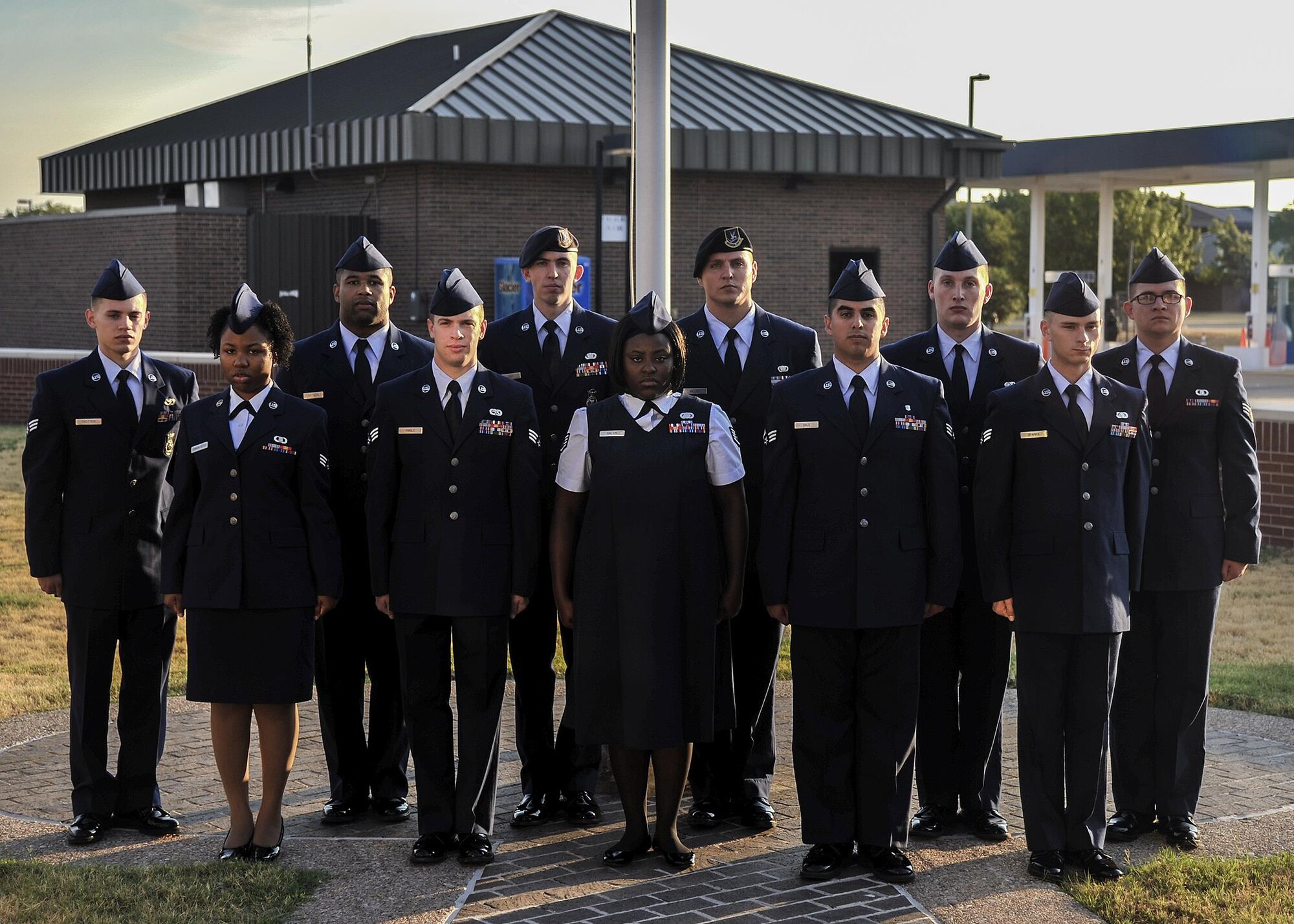 Students from Airman Leadership School Class 15-E pose for a group photo in front of the flag pole at the Consolidated Learning Center, Goodfellow Air Force Base, Texas, Aug. 18, 2015. The students graduated Aug. 28, 2015. (U.S. Air Force photo by Airman 1st Class Devin Boyer/Released)