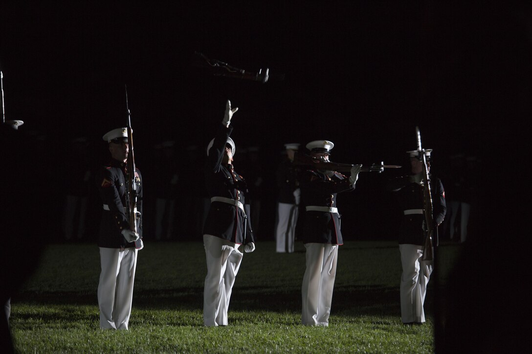 The Silent Drill Platoon performs during a Friday Evening Parade at Marine Barracks Washington, D.C., Aug. 28, 2015. Two Marine Barracks Washington Marines, Sgt. Jonathan W. Patrick, Alpha Company, and Lance Cpl. Kyle F. McDonald, Guard Company, were the guests of honor for the parade and Gen. Joseph F. Dunford Jr., 36th commandant of the Marine Corps, was the hosting official. (U.S. Marine Corps photo by Cpl. Skye Davis/Released)