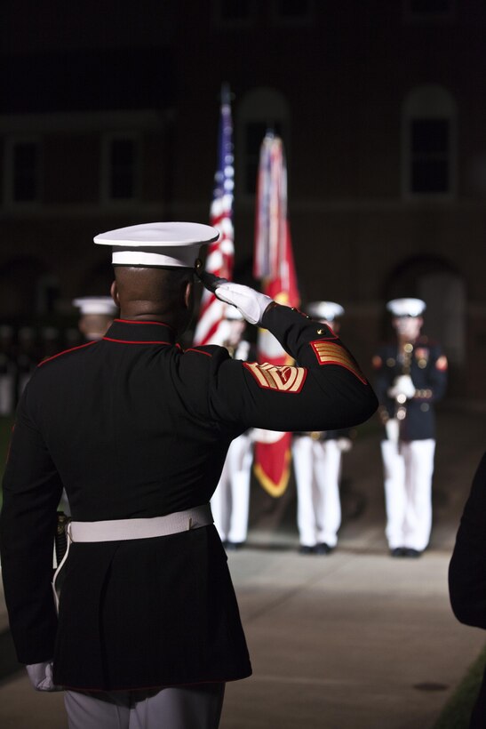 A U.S. Marine with Marine Barracks Washington, D.C., salutes during an evening parade, Aug. 28, 2015. U.S. Marines Sgt. Jonathan W. Patrick and Lance Cpl. Kyle F. McDonald were the guests of honor for the parade and Gen. Joseph F. Dunford Jr., 36th commandant of the Marine Corps, was the hosting official for that same parade. The Evening Parade summer tradition began in 1934 and features the Silent Drill Platoon, the Marine Band, the U.S. Marine Drum and Bugle Corps and two marching companies. More than 3,500 guests attend the parade every week. (U.S. Marine Corps photo by Lance Cpl. Alex A. Quiles/Released)
