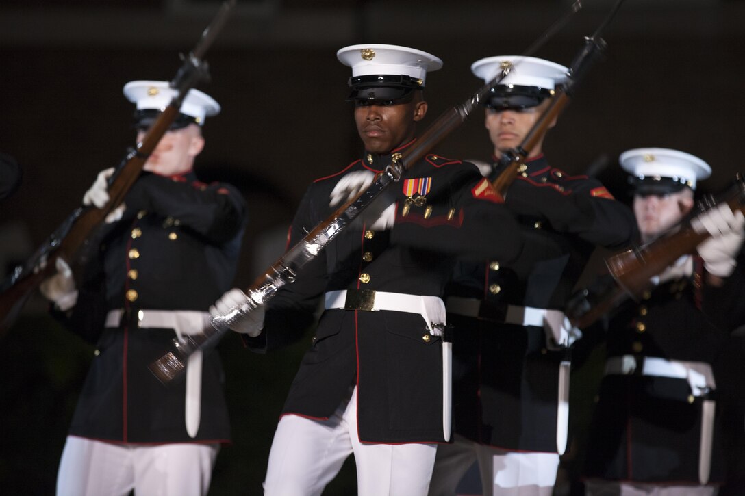 The U.S. Marine Corps Silent Drill Platoon performs during an evening parade at Marine Barracks Washington, D.C., Aug. 28, 2015. U.S. Marines Sgt. Jonathan W. Patrick and Lance Cpl. Kyle F. McDonald were the guests of honor for the parade and Gen. Joseph F. Dunford Jr., 36th commandant of the Marine Corps, was the hosting official for that same parade. The Evening Parade summer tradition began in 1934 and features the Silent Drill Platoon, the Marine Band, the U.S Marine Drum and Bugle Corps and two marching companies. More than 3,500 guests attend the parade every week. (U.S. Marine Corps photo by Lance Cpl. Alex A. Quiles/Released)
