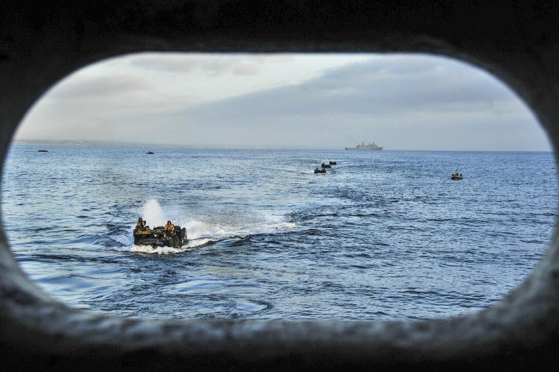 Amphibious assault vehicles prepare to enter the well deck of the amphibious transport dock ship USS New Orleans during Dawn Blitz 2015 in the Pacific Ocean, Aug. 21, 2015. The training exercise, which involves U.S., Japanese, Mexican and New Zealand troops, aims to enhance each country's ability to activate an amphibious task force. U.S. Navy photo by Petty Officer 3rd Class Brandon Cyr


