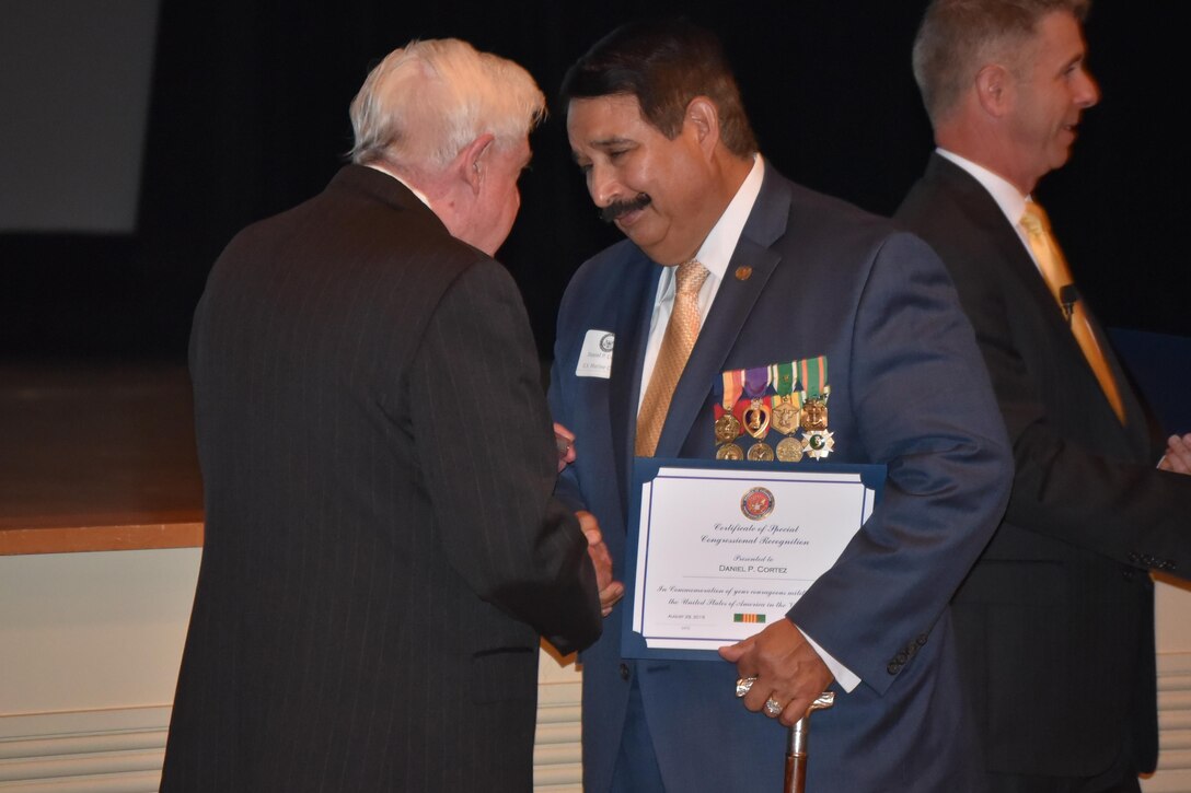 Daniel P. Cortez. a Marine veteran and Purple Heart recipient, received a commemorative pin and certificate of appreciation from retired Lt. Gen. George R. Christmas, president of the Marine Corps Heritage Foundation.
