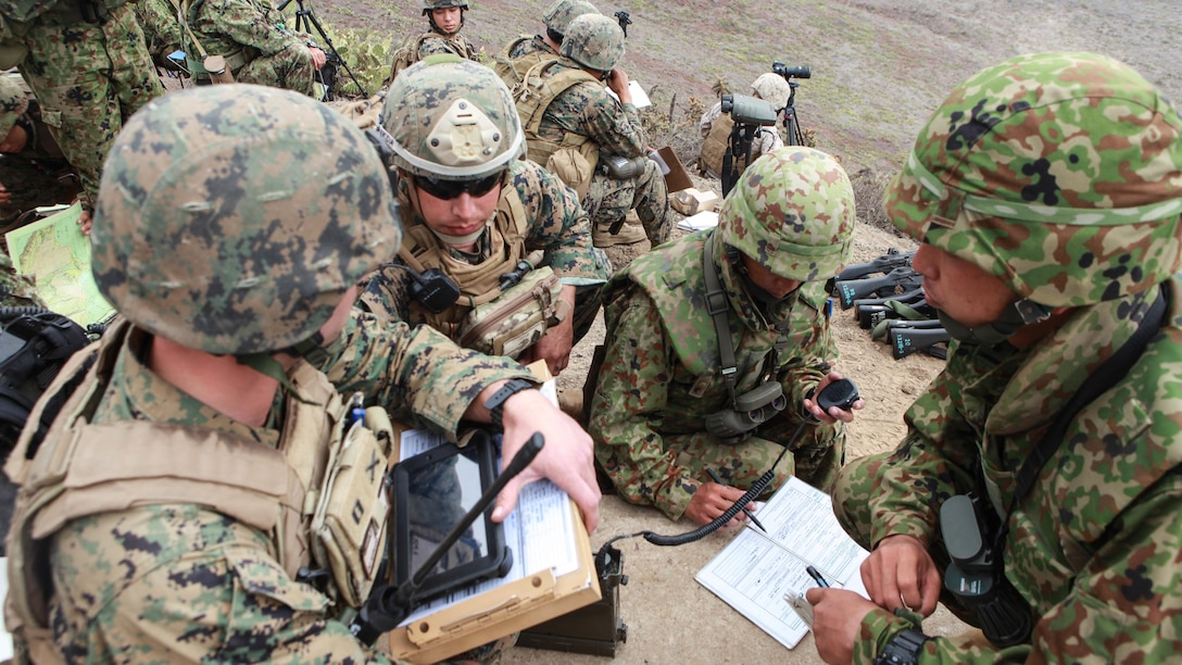 Marines with 3rd Air Naval Gunfire Liaison Company and Japanese soldiers coordinate plans during a combined arms shoot with naval gunfire, attack rotary aircraft and 120mm mortars at San Clemente Island, California, Sept. 1, 2015. ANGLICO Marines and Japanese soldiers conducted the live-fire shoot as part of Exercise Dawn Blitz 2015. Dawn Blitz is a multinational training exercise designed to enhance Expeditionary Strike Group Three and 1st Marine Expeditionary Brigade’s ability to conduct sea-basing operations, amphibious landings, and command and control capabilities alongside Japan, Mexico and New Zealand.