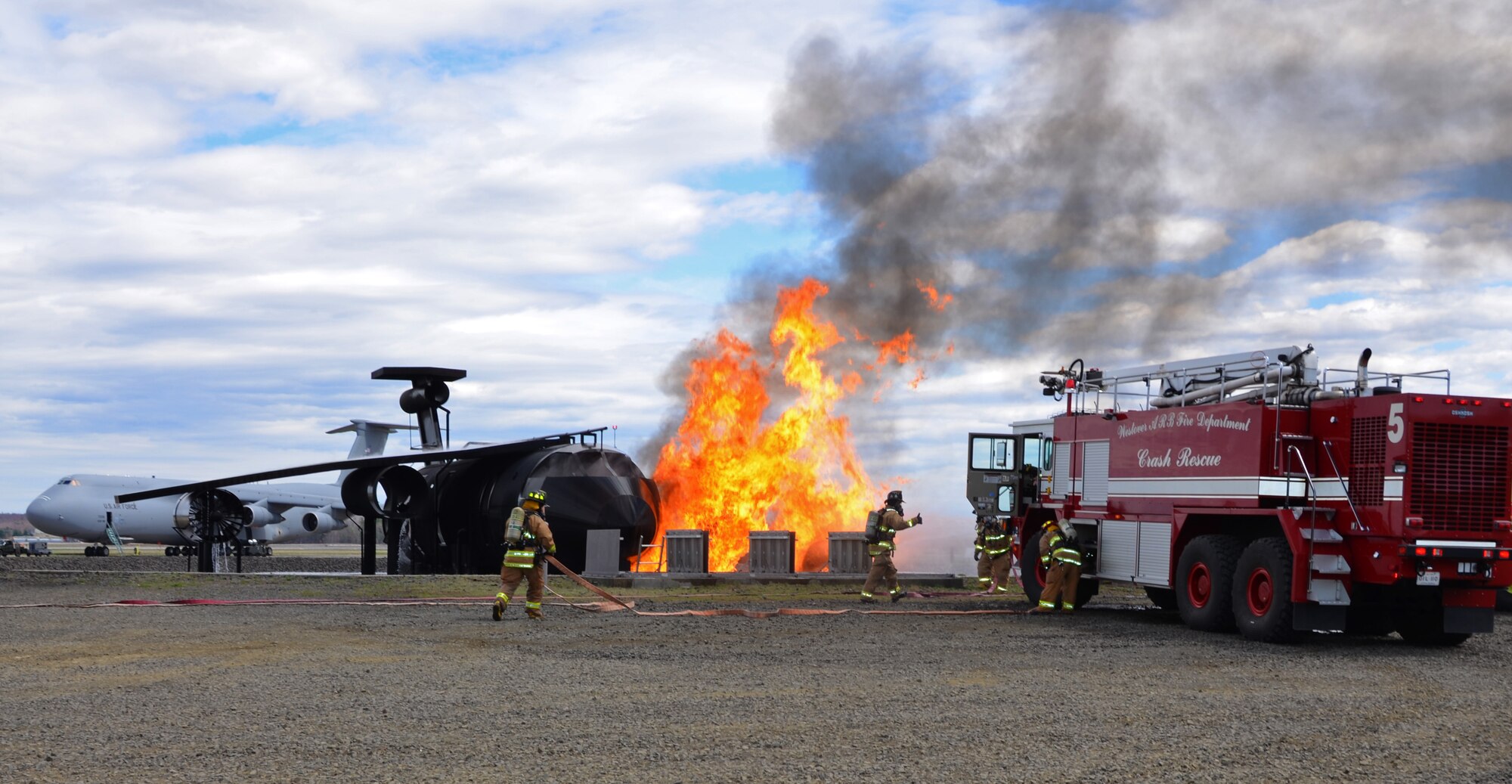 Westover Fire Department firefighters extinguish a fire, utilizing the fire training simulator on base.
