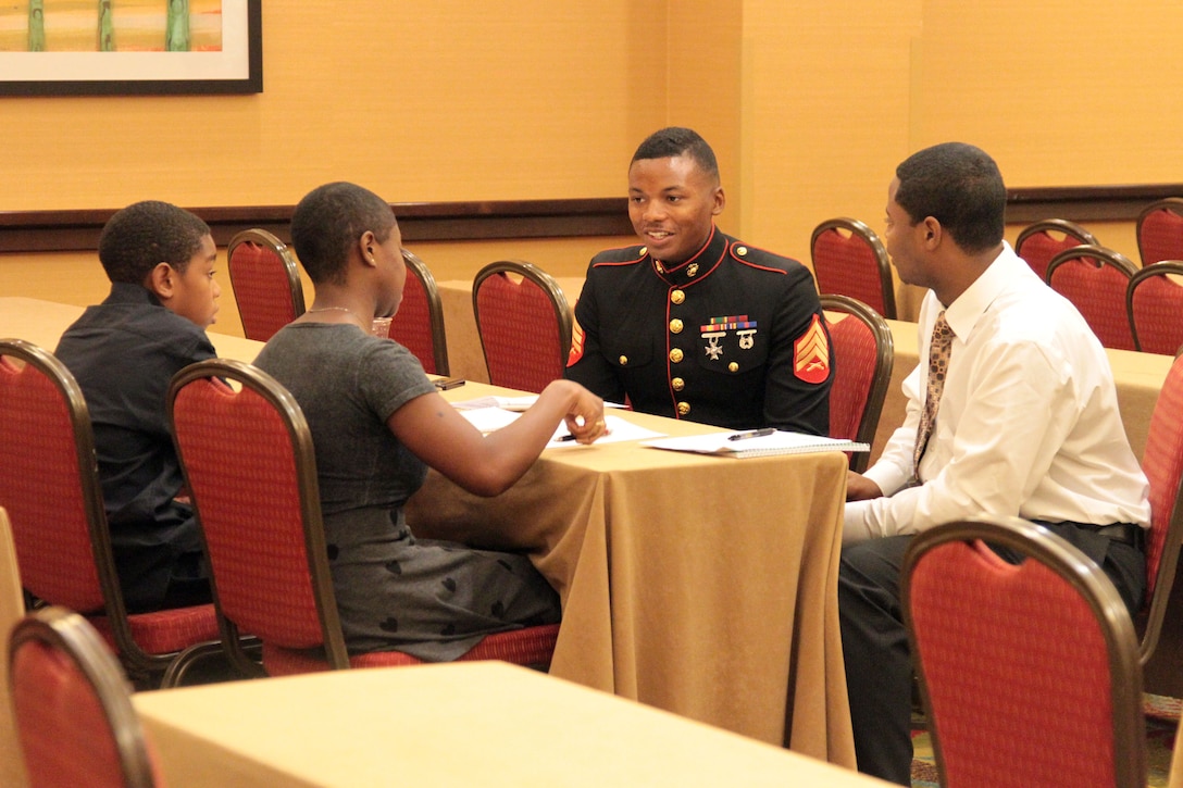 SACRAMENTO – Sgt. Reuben Smith, IV, officer selection assistant, Recruiting Station Sacramento, mentors participants at the Ron Brown Business and Economic Summit here, Aug. 29, 2015. The California Black Chamber of Commerce hosted a youth summit at the event to teach local youths about leadership and business skills. The participants formulated business plans and presented to a panel, who critiques and advised them.
(U.S. Marine Corps photo by Staff Sgt. Jacob Harrer)
