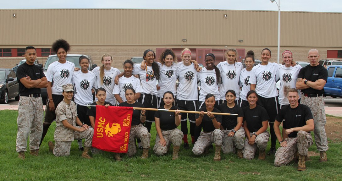 The San Diego State University women's basketball team and Marines from Marine Corps Recruiting Station San Diego pose for a picture following a fitness challenge aboard Marine Corps Air Station Miramar, Calif., Sept. 1, 2015.