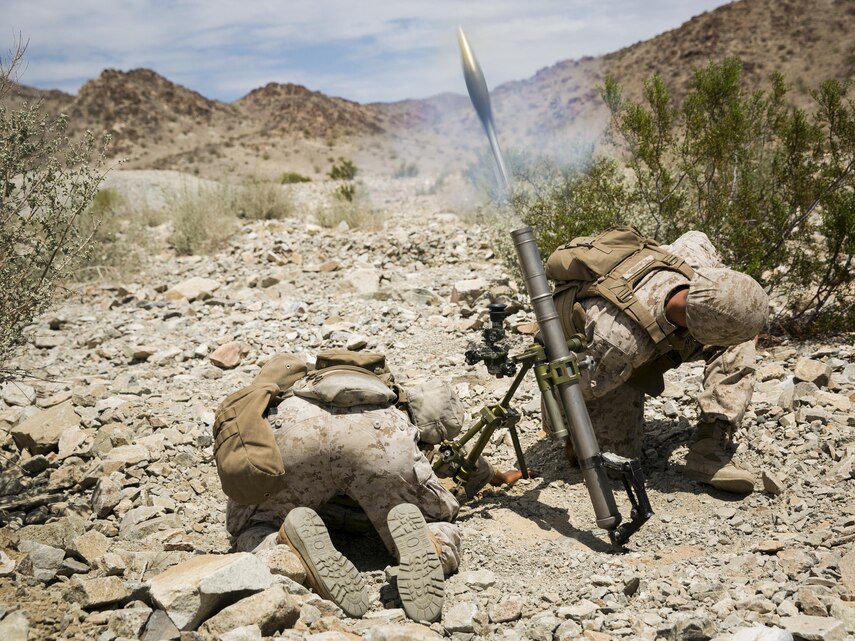 Pfc. Anthony C. Alamillo and Pfc. Nathan S. Barnes, mortar men, Weapons Company, 2nd Battalion, 7th Marine Regiment, provide support fire with a M224A1 60mm Mortar System during Exercise Chosin, a squad-level training evolution, at Range 410, August 26, 2015. The Marines with Weapons Company provided support to Company E as they executed an assault course. (Official Marine Corps photo by Pfc. Levi Schultz/Released)