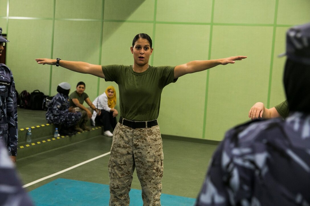 QATAR (Aug 18, 2015)
U.S. Marine Cpl. Justine Woodend demonstrates the Marine Corps Martial Arts Program to members of the Qatari Internal Security Forces Female VIP Protection Unit during a Subject Matter Expert Exchange in Qatar. Woodend is a motor transportation operator with Combat Logistics Battalion 15, 15th Marine Expeditionary Unit and a member of the Female Partner Force Engagement Team. The FPFET was comprised of U.S. Marines with the 15th Marine Expeditionary Unit as well as Soldiers and Sailors with Special Operations Command Central-Forward and Joint Special Operations Task Force-Arabian Peninsula. During the SMEE they covered medical care, marksmanship, and personal security detail strategies. (U.S. Marine Corps photo by Cpl. Anna Albrecht/ Released)