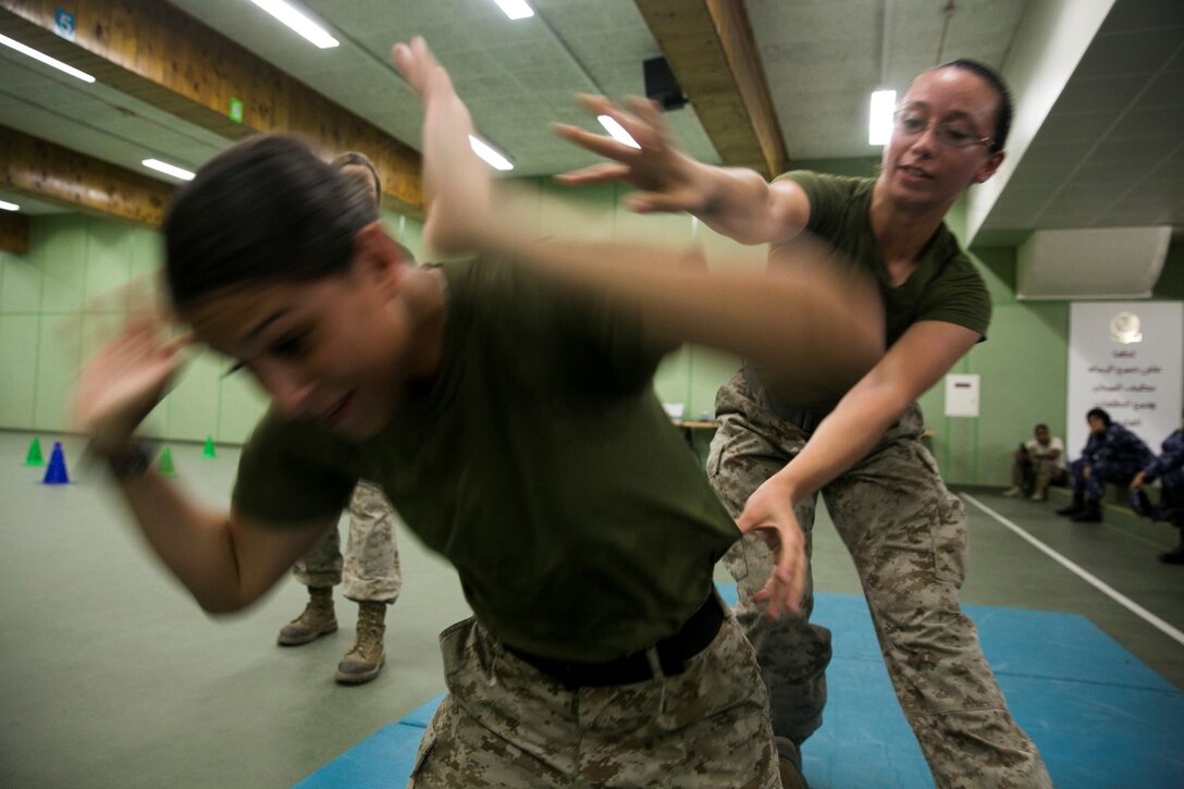 QATAR (Aug 18, 2015)
U.S. Marines Cpl. Justine Woodend, left, and Lance Cpl. Chevon Ferrel demonstrate searching techniques during a subject matter expert exchange with the Qatari Internal Security Forces Female VIP Protection Unit in Qatar. Woodend is a motor transportation operator and Ferrel is an ammunition technician with the 15th Marine Expeditionary. They are members of the Female Partner Force Engagement Team. The FPFET was comprised of U.S. Marines with the 15th MEU as well as Soldiers and Sailors with Special Operations Command Central-Forward and Joint Special Operations Task Force-Arabian Peninsula. During the SMEE they covered medical care, marksmanship, and personal security detail strategies. (U.S. Marine Corps photo by Cpl. Anna Albrecht/Released)
