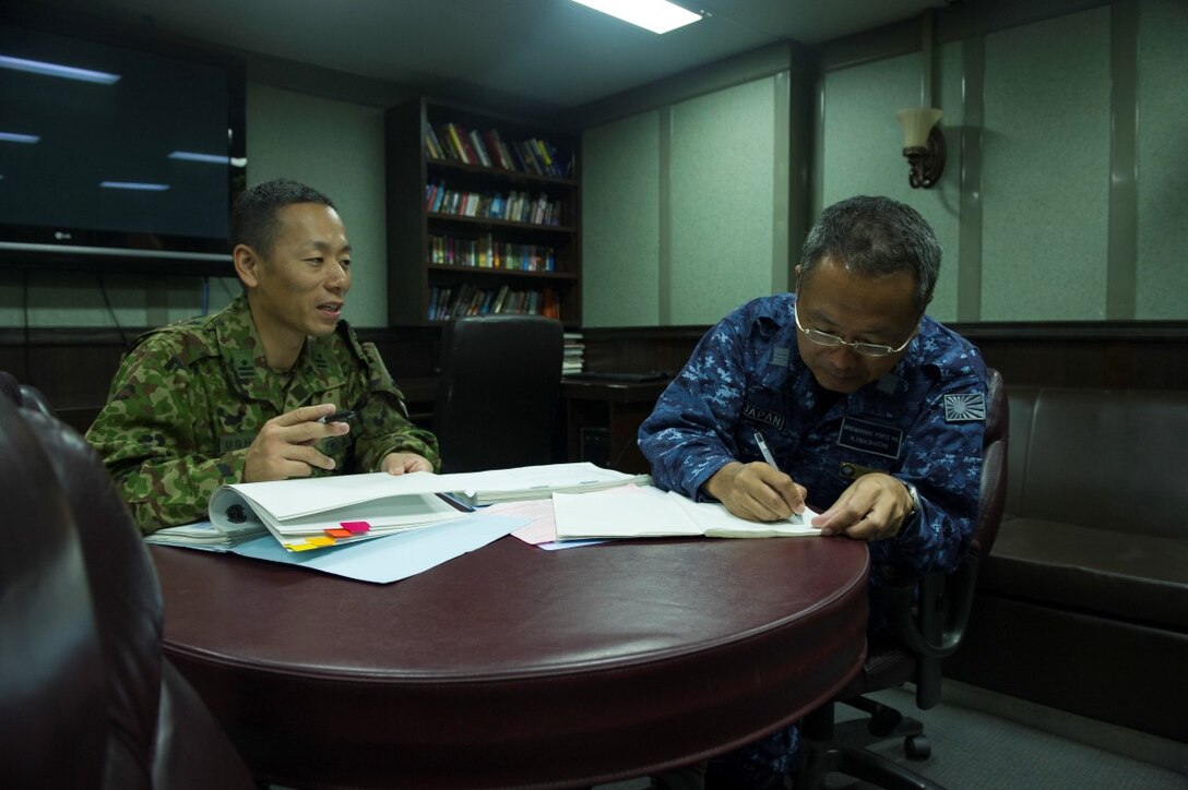 150901-N-GM561-134 PACIFIC OCEAN (Sept. 1, 2015) Maj. Toshinori Ushio, attached to the Japanese Self Defense Force, left, and Lt. Cmdr. Haruyan Irabuchi, attached to the Japanese Mine Warfare Force, work together aboard the amphibious assault ship USS Boxer (LHD 4) during a meeting. Boxer is currently underway off the coast of Southern California participating in Dawn Blitz 2015 (DB-15).  DB-15 is a multinational training exercise being conducted by Expeditionary Strike Group 3 (ESG-3) and 1st Marine Expeditionary Brigade (1st MEB) to build U.S., Japan, Mexico and New Zealand’s amphibious, and command and control capabilities through live, simulated, and constructive military training activities. (U.S. Navy photo by Mass Communication Specialist 3rd Class Veronica Mammina/Released)