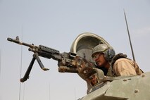 A Marine with 3rd Battalion, 1st Marine Regiment, 15th Marine Expeditionary Unit, posts security during atop an Amphibious Assault Vehicle during a Fire Support Coordination Exercise (FSCEX) in an undisclosed location in Southwest Asia, Aug. 25, 2015. The FSCEX is a SPMAGTF and 15th Marine Expeditionary Unit combined arms exercise designed to promote interoperability between the two Marine Corps contingency response forces in the Central Command Area of Operations. The 15th MEU is embarked on the Essex Amphibious Ready Group and deployed to maintain regional security in the U.S. 5th Fleet area of operations. (U.S. Marine Corps photo by Cpl. Jonathan Boynes)
