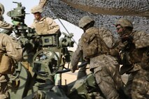 Artillery Marines with India Battery, Battalion Landing Team 3rd Battalion, 1st Marine Regiment, 15th Marine Expeditionary Unit, load and prepare to fire an M777 Howitzer during a Fire Support Coordination Exercise (FSCEX) in an undisclosed location in Southwest Asia, Aug. 25, 2015. The FSCEX is a SPMAGTF and 15th Marine Expeditionary Unit combined arms exercise designed to promote interoperability between the two Marine Corps contingency response forces in the Central Command Area of Operations. BLT 3/1, 15th MEU’s ground combat element, is embarked on the Essex Amphibious Ready Group and deployed to maintain regional security in the U.S. 5th Fleet area of operations. (U.S. Marine Corps photo by Cpl. Jonathan Boynes)