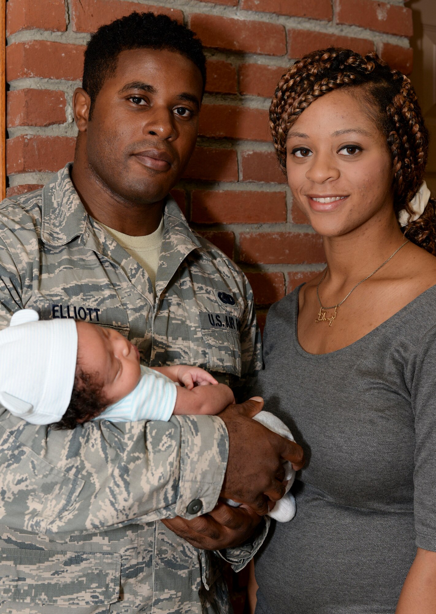 Staff Sgt. Darryal Elliott Jr., 2nd Logistics Readiness Squadron fuels mobile distribution NCO in charge, poses for a photo with his wife, Latonya, and son, Darryal Elliot III, at Barksdale Air Force Base, La., Aug. 26, 2015. Elliott rushed to the hospital immediately after he came home from a TDY. His son was born minutes after his arrival at the hospital. (U.S. Air Force Photo/Senior Airman Amanda Morris)