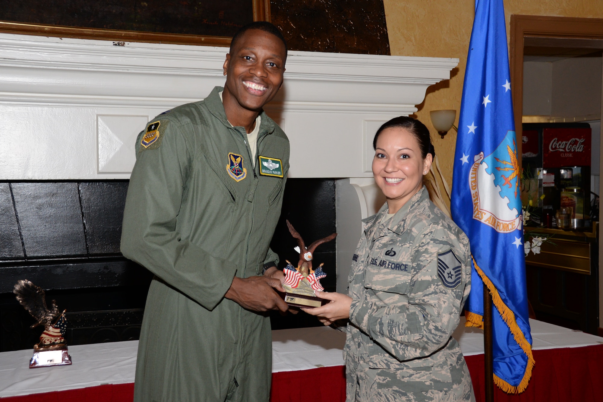 Col. Brandon Parker, 2nd Bomb Wing vice commander, presents a Combined Federal Campaign spirit award to Master Sgt. Crystal Velez-Greenhill, Air Force Global Strike Command quality assurance manager, during the CFC kick-off breakfast at Barksdale Air Force Base, La., Sept. 1, 2015. The CFC has adopted “You Can Change a Life” as the theme for 2015. Through the CFC, federal employees contributed more than $193 million last year to different causes and charities across the nation.  (U.S. Air Force photo/Senior Airman Amanda Morris)