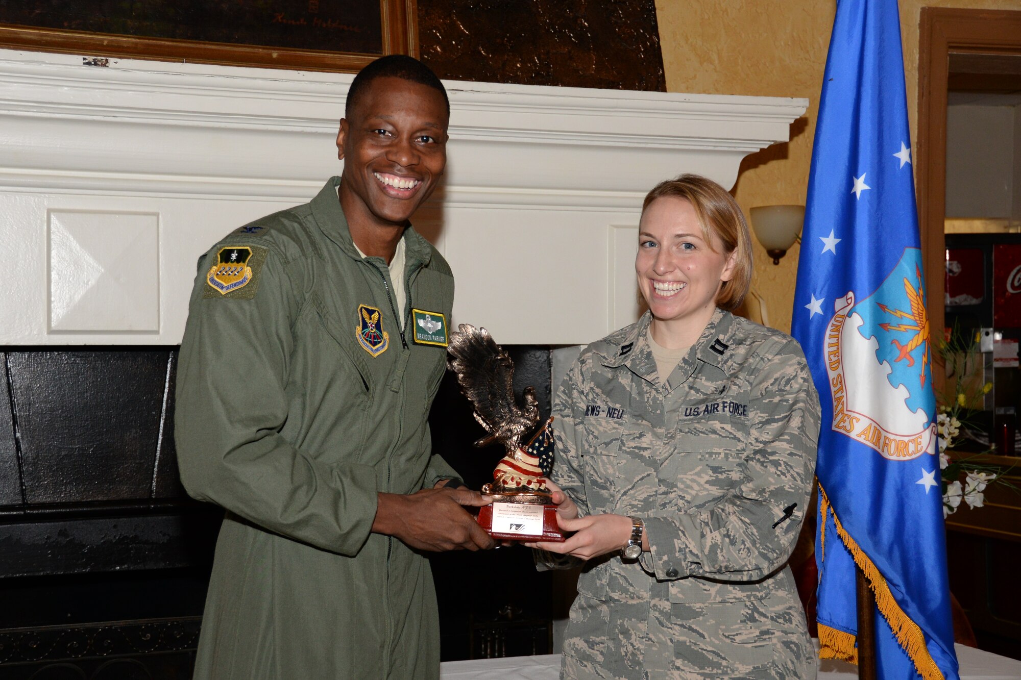 Col. Brandon Parker, 2nd Bomb Wing vice commander, presents an award to Capt. Molly Matthews-Neu, 2nd Medical Group medical readiness flight commander, during the Combined Federal Campaign kick-off breakfast at Barksdale Air Force Base, La., Sept. 1, 2015. Federal employees have donated more than $7 billion to various causes and charities since the CFC’s 1964 inception. (U.S. Air Force photo/Senior Airman Amanda Morris)