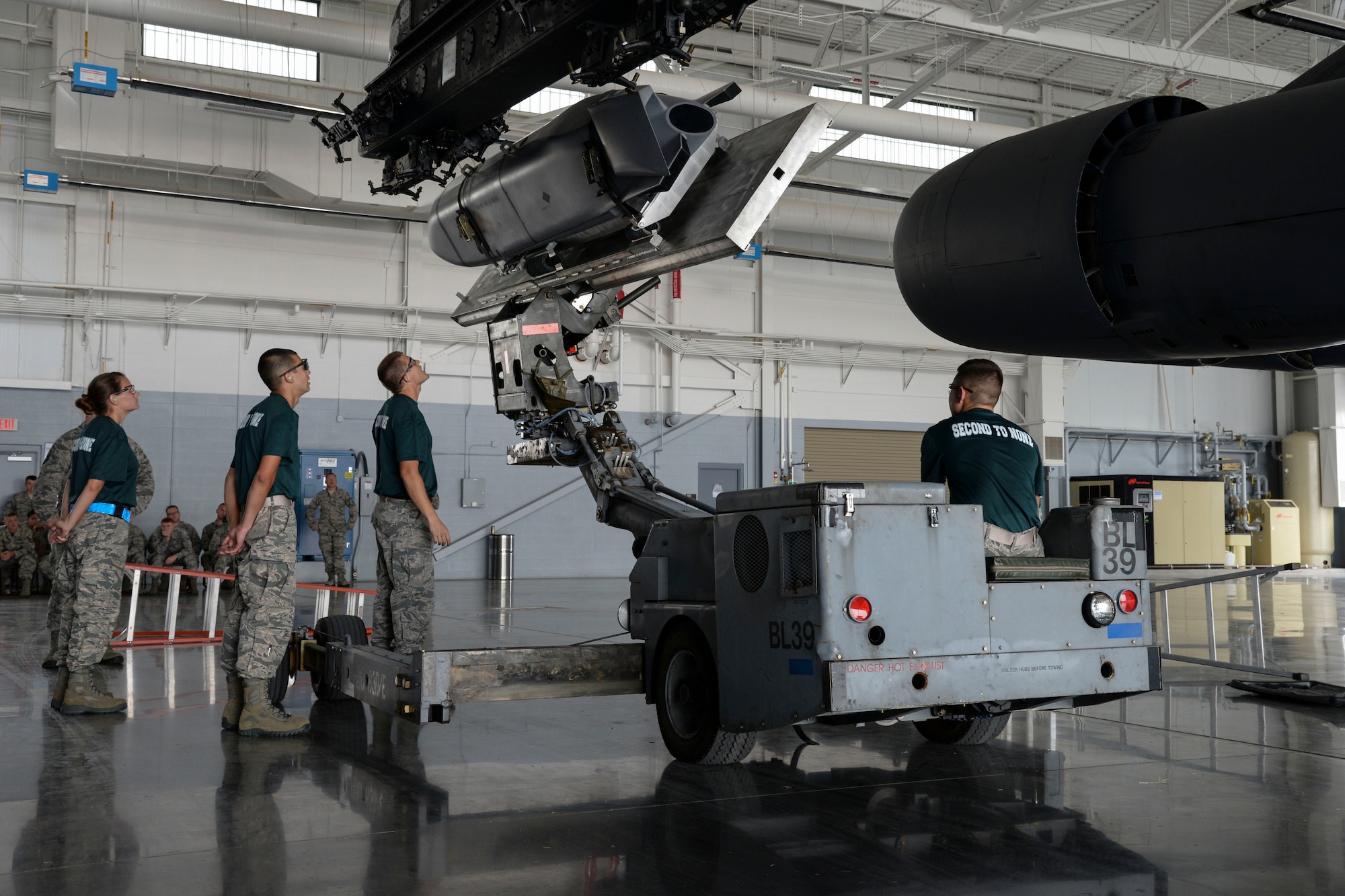 Airman 1st Class David Botterill, 2nd Aircraft Maintenance Squadron conventional load team, lifts an AGM-158 to a pylon during the 2015 Global Strike Challenge at Barksdale Air Force Base, La., Aug. 31. The four-person team is competing against other bases within Air Force Global Strike Command for the title of the best conventional load team in AFGSC. (U.S. Air Force photo/ Senior Airman Jannelle Dickey)
