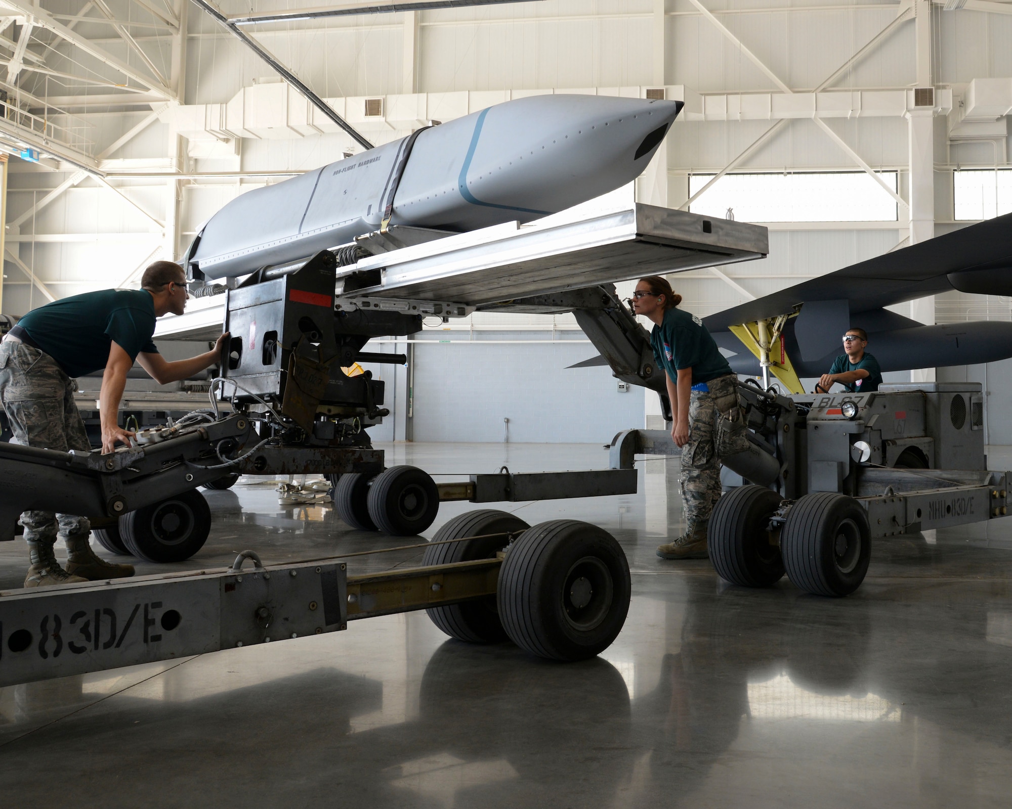 Senior Airman Jeremy Pratta and Staff Sgt. Marcella Phillips, 2nd Aircraft Maintenance Squadron conventional load team, oversee the transfer of an AGM-158 between jammers during the 2015 Global Strike Challenge at Barksdale Air Force Base, La., Aug. 31. The objective of the competition is to demonstrate bomber maintenance procedures and enhance esprit de corps by recognizing crew, team, individual and unit professionalism. (U.S. Air Force photo/ Senior Airman Jannelle Dickey)