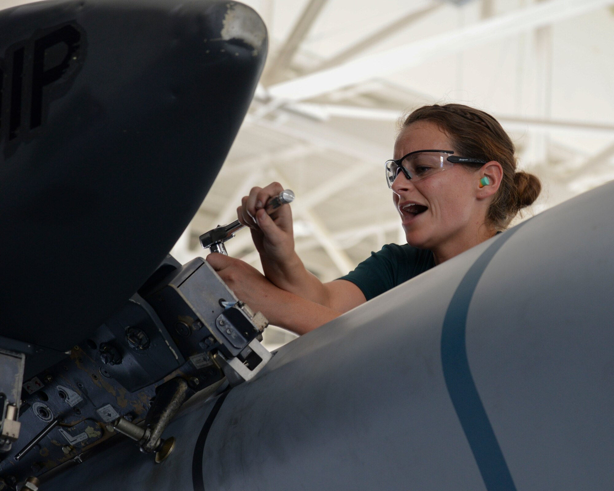 Staff Sgt. Marcella Phillips, 2nd Aircraft Maintenance Squadron conventional load team, secures an AGM-158 to a pylon during the 2015 Global Strike Challenge at Barksdale Air Force Base, La., Aug. 31. As Phillips finished securing the missile to the pylon, she signaled to her team to start the next loading process. (U.S. Air Force photo/ Senior Airman Jannelle Dickey)